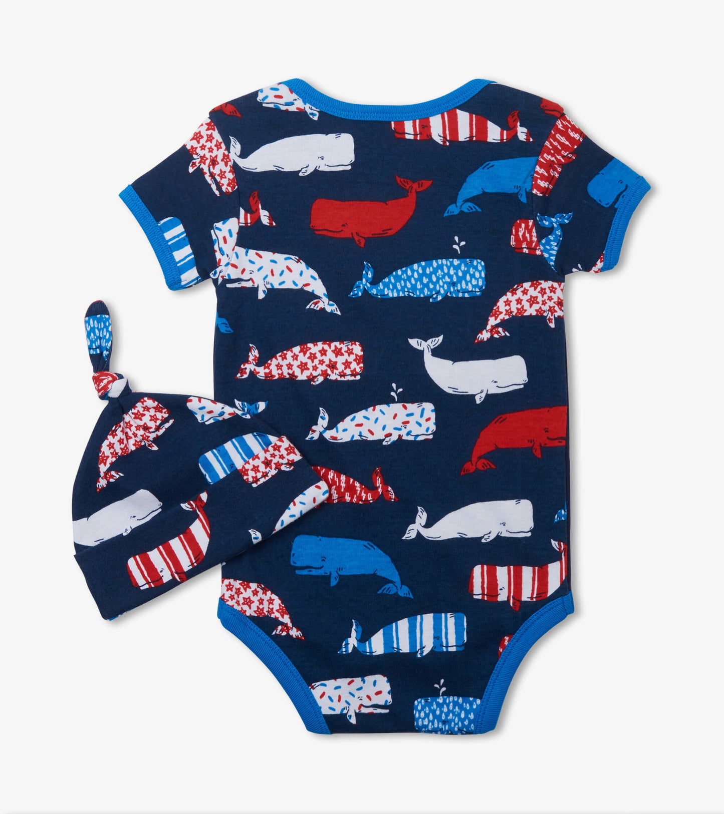 Navy blue bodysuit with colorful whale patterns, paired with a matching hat featuring similar designs.