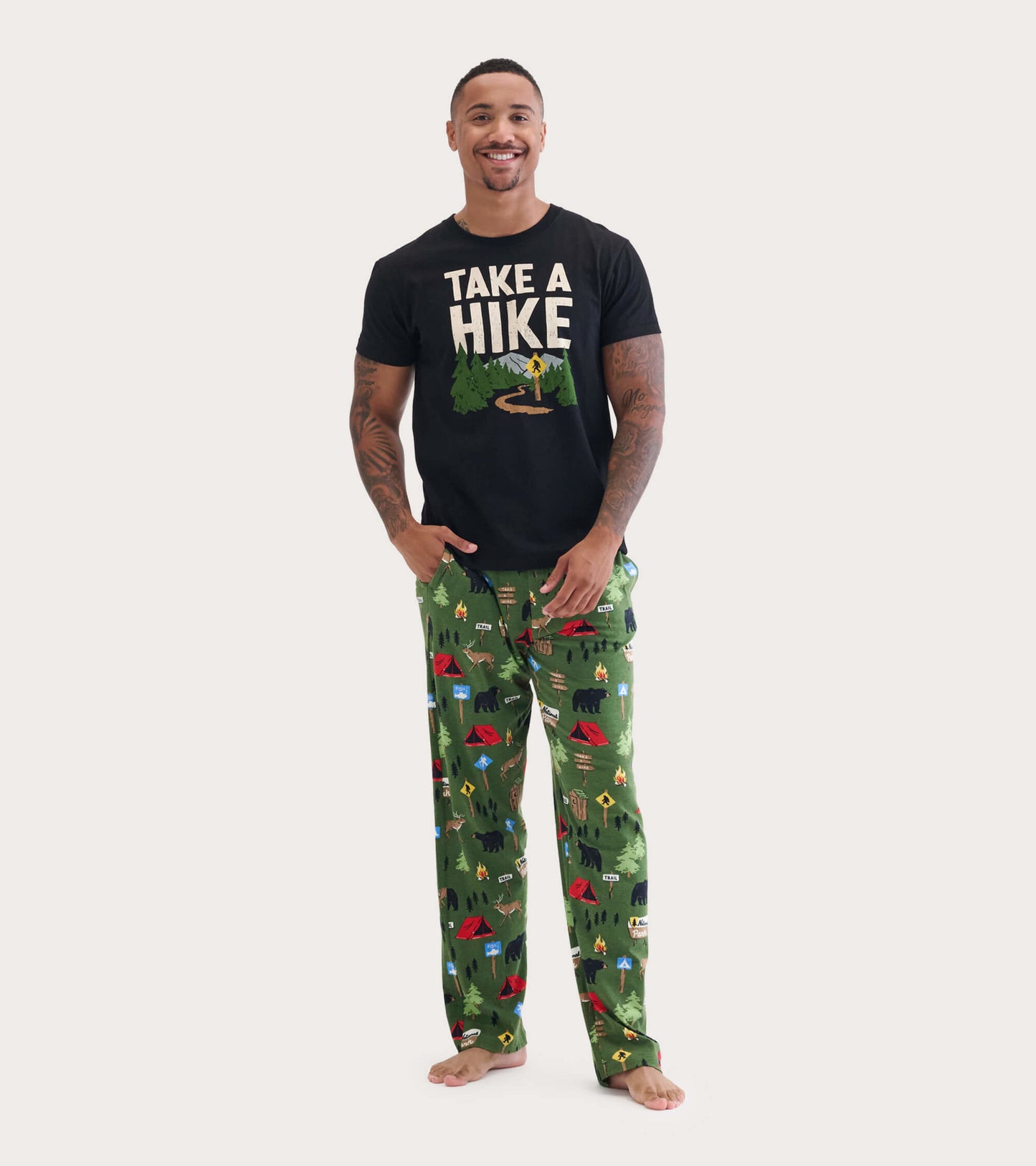 Men's green cotton pajama pants featuring a camping and wildlife pattern, styled for comfort and relaxation.
