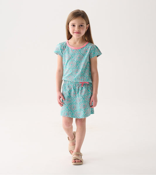 Turquoise t-shirt dress with pink accents and a playful pattern, featuring short sleeves and an elastic waist.