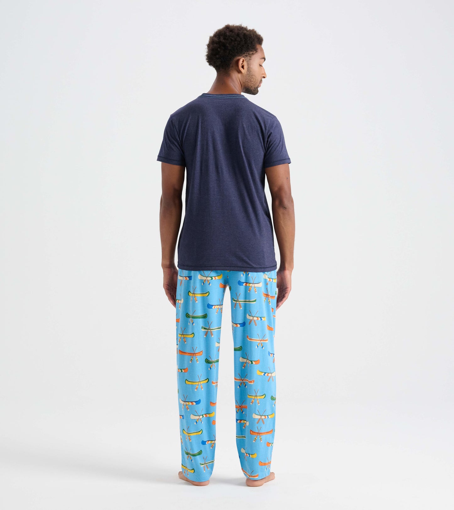 Men's cotton pajama pants in light blue with colorful canoe patterns, shown from the back.