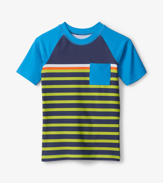 Short sleeve rashguard featuring blue sleeves, navy body, and colorful horizontal stripes with a chest pocket.