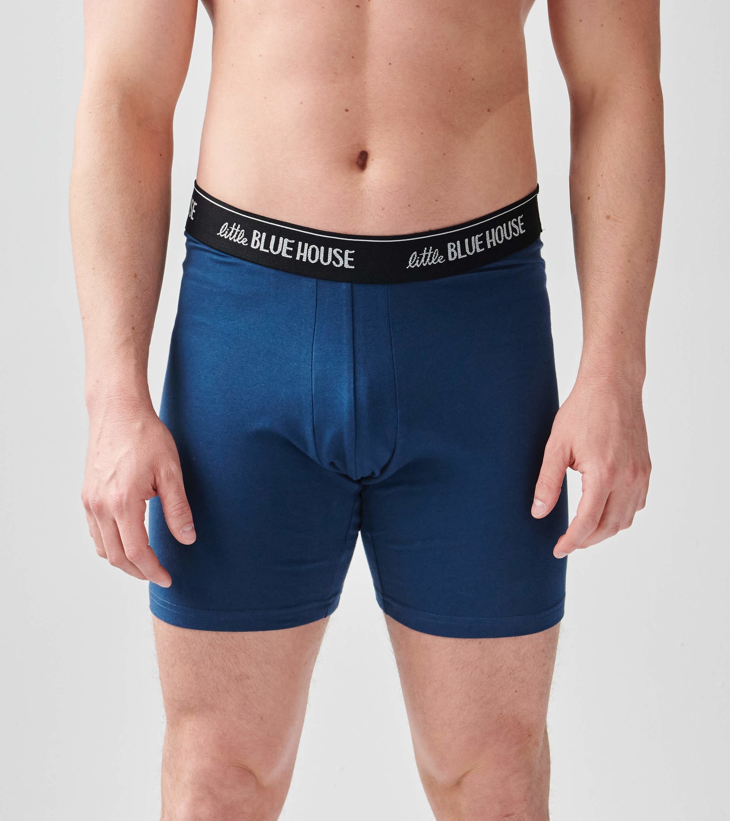 Navy blue men's boxer briefs with a black elastic waistband, featuring a snug fit and smooth fabric.