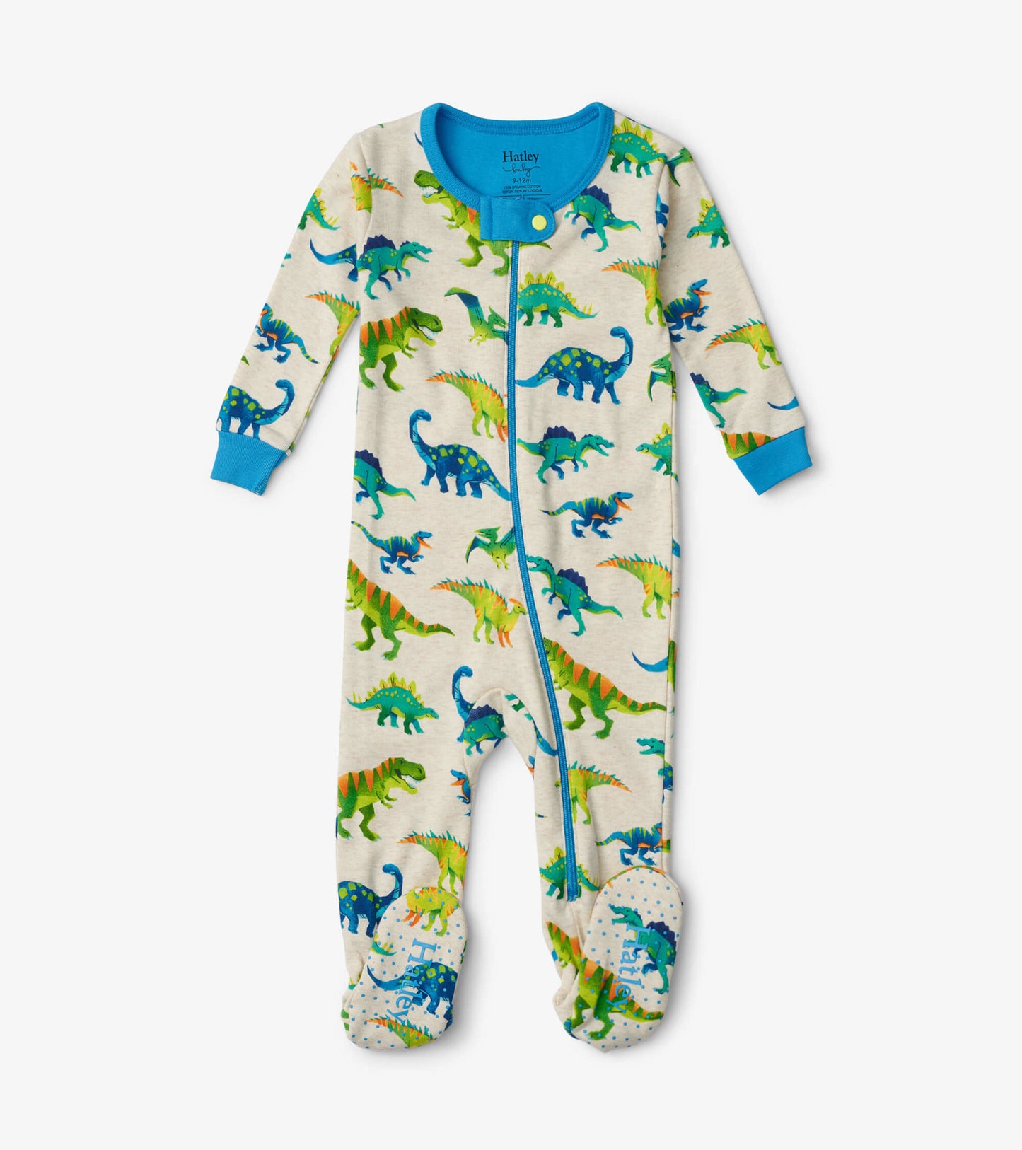 Colourful dinosaur print footed sleeper in cream with blue accents, featuring long sleeves and a front zipper.