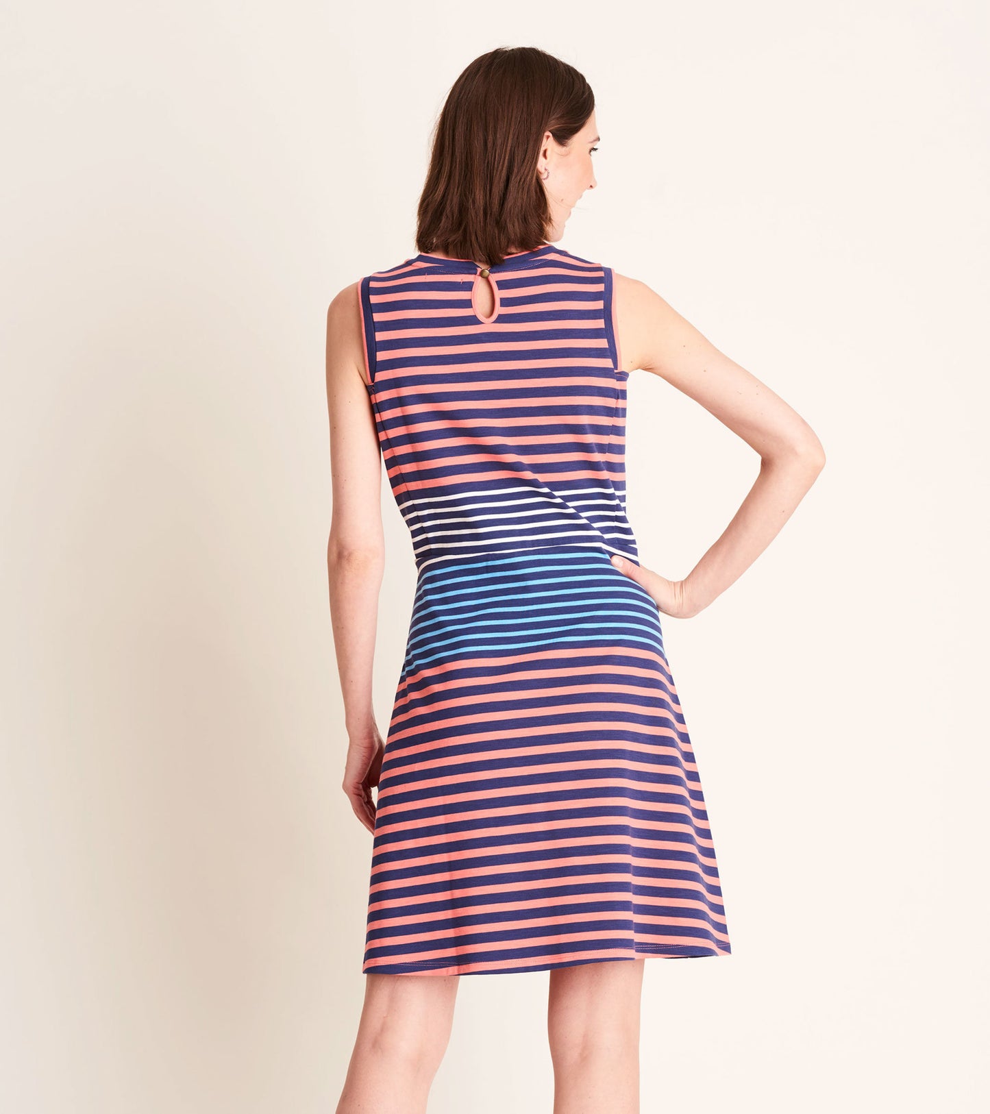 Sleeveless navy dress with coral and blue stripes, featuring a keyhole back detail and a relaxed fit.