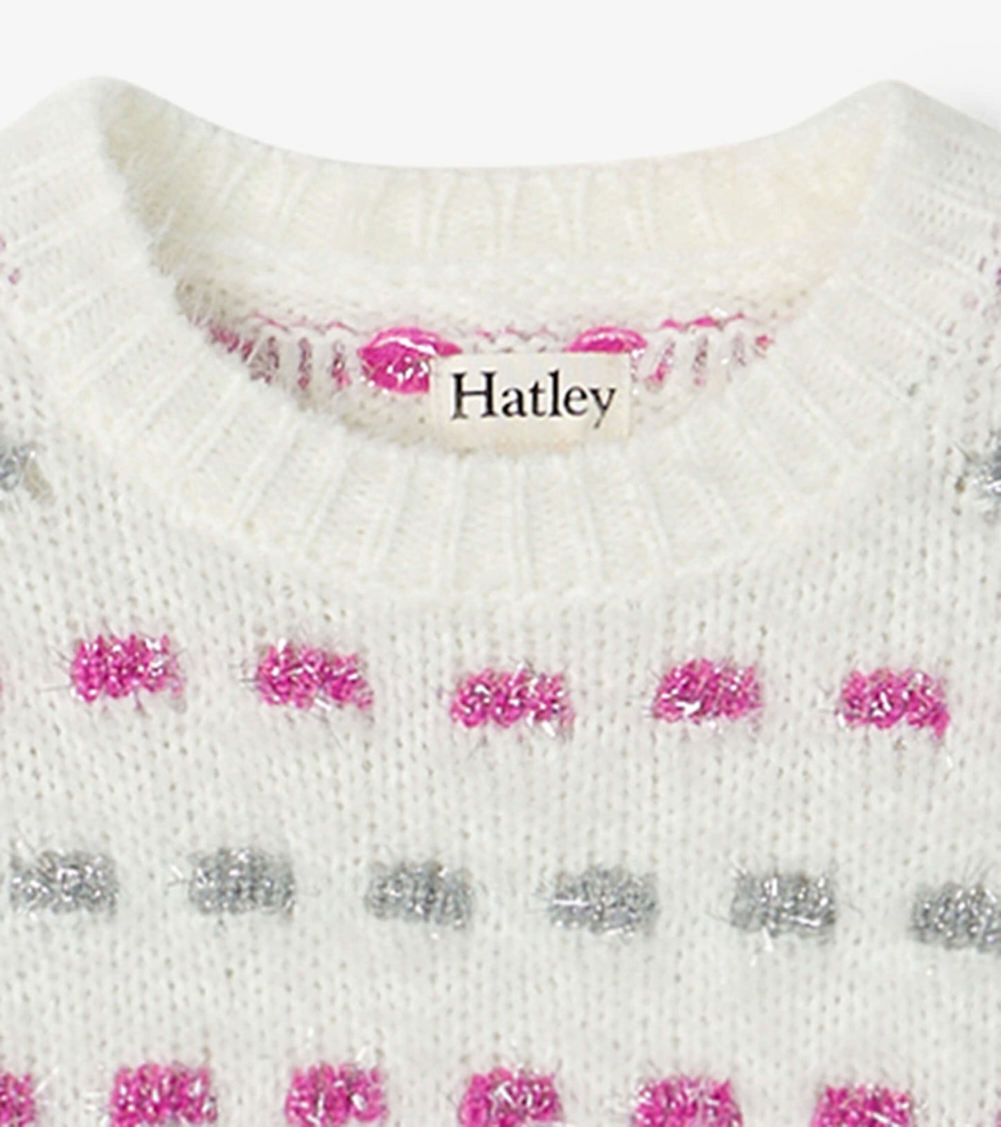 White sweater tunic featuring a basket weave pattern with pink and silver dots, round neckline, and ribbed trim.