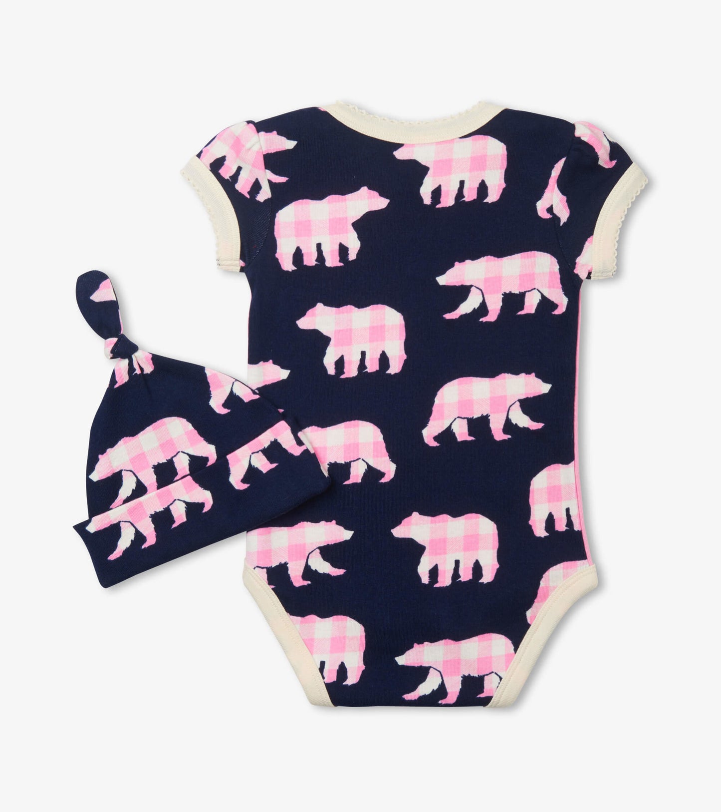 Pink bear-patterned bodysuit with short sleeves and matching hat, set against a navy background.