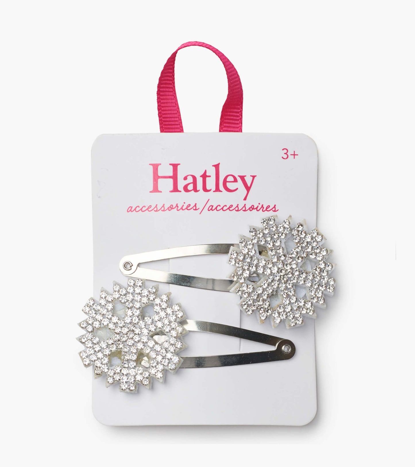 Silver snap clips featuring sparkling snowflake designs, mounted on a card with a pink hanging loop.
