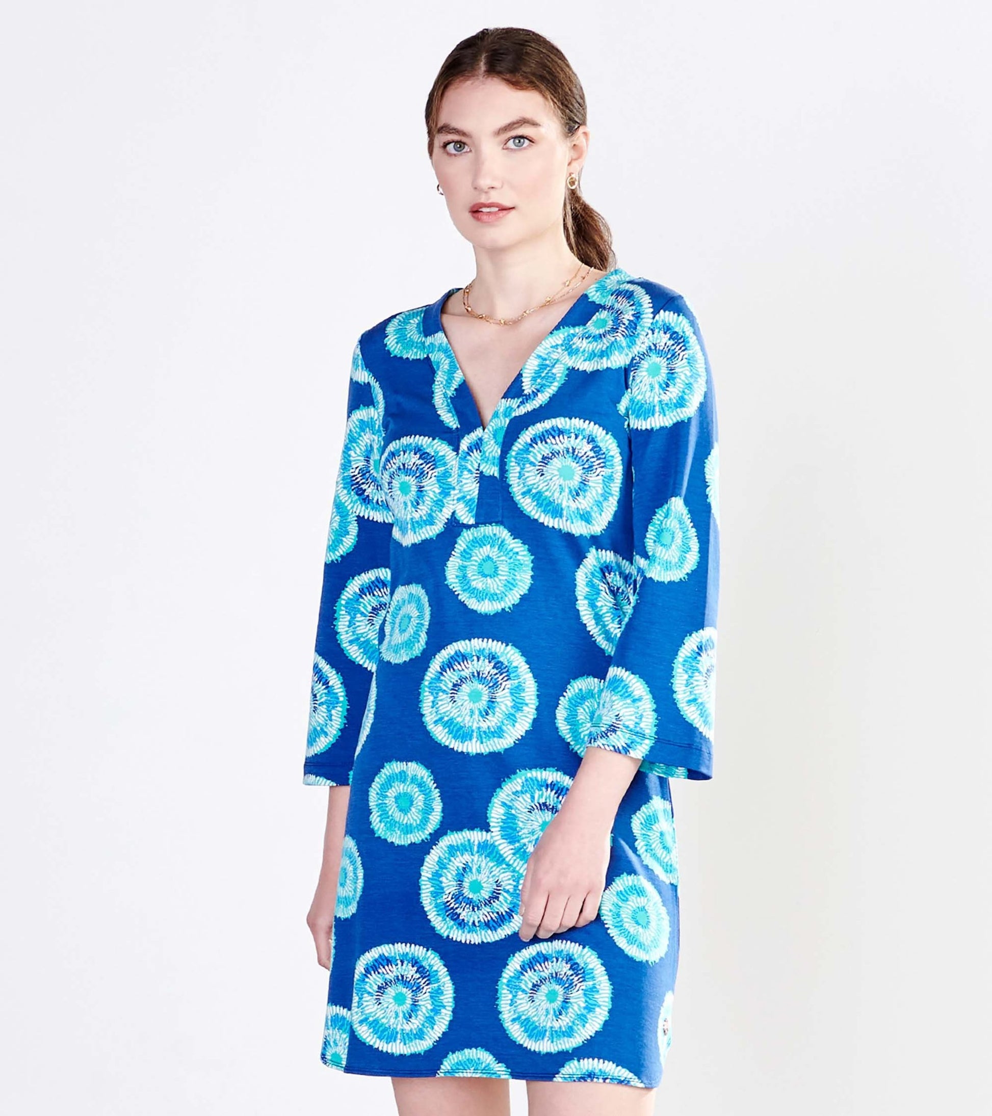 Blue dress with a vibrant circular pattern and three-quarter sleeves, featuring a V-neckline.