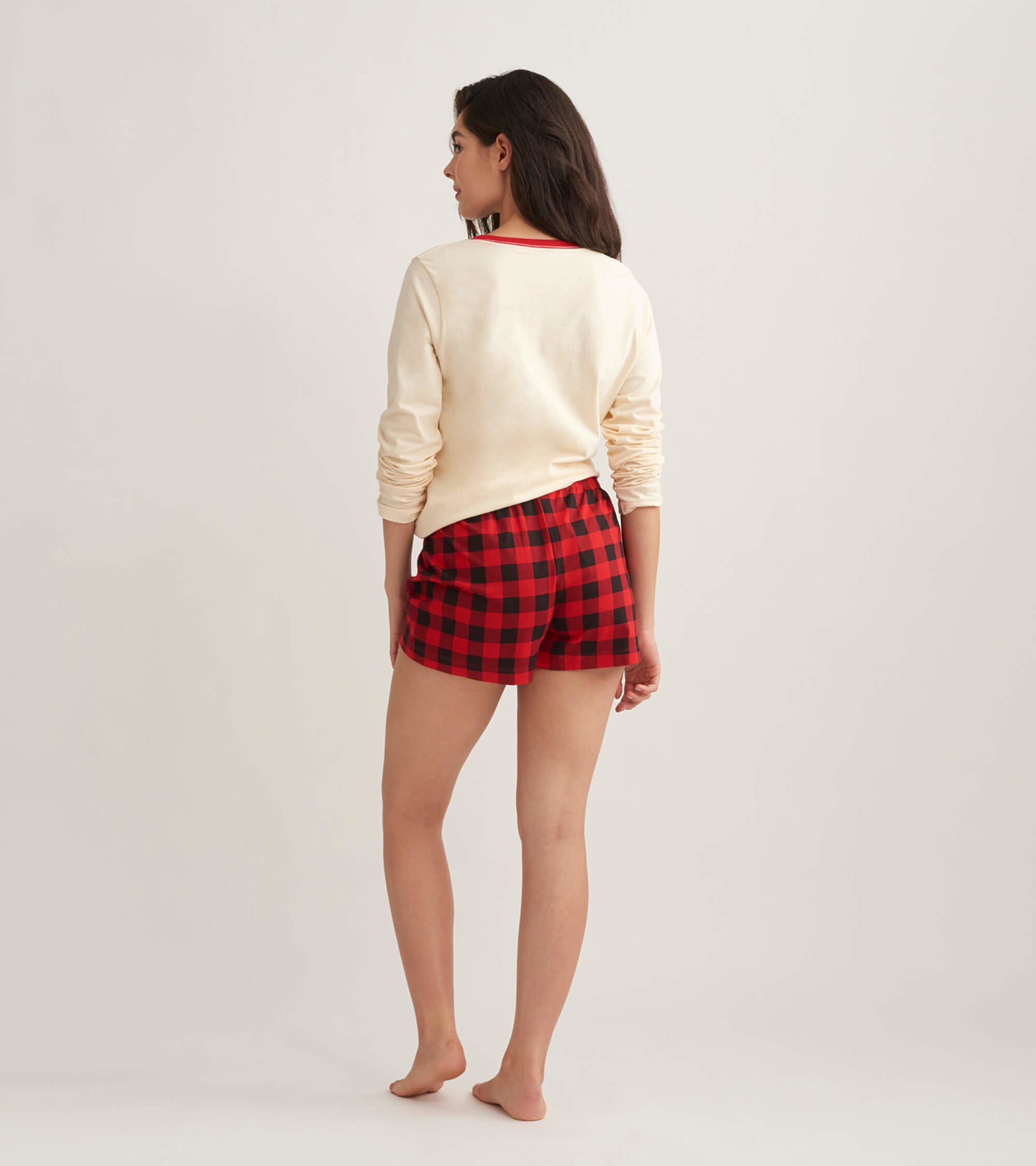Red and black buffalo plaid cotton sleep shorts with an elastic waistband, shown from the back.