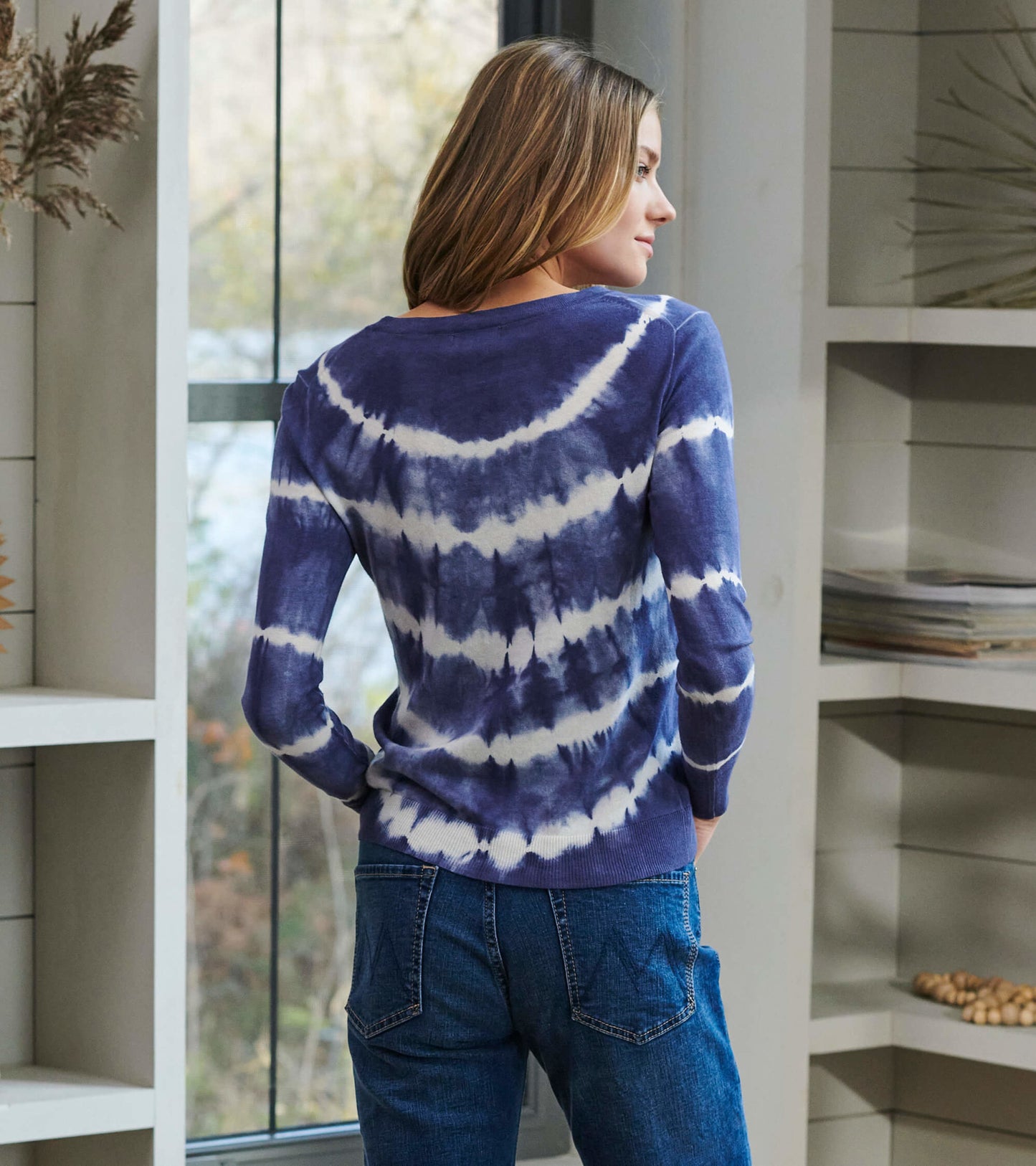 Long-sleeve sweater in purple and white tie-dye pattern, featuring a relaxed fit and ribbed hem.