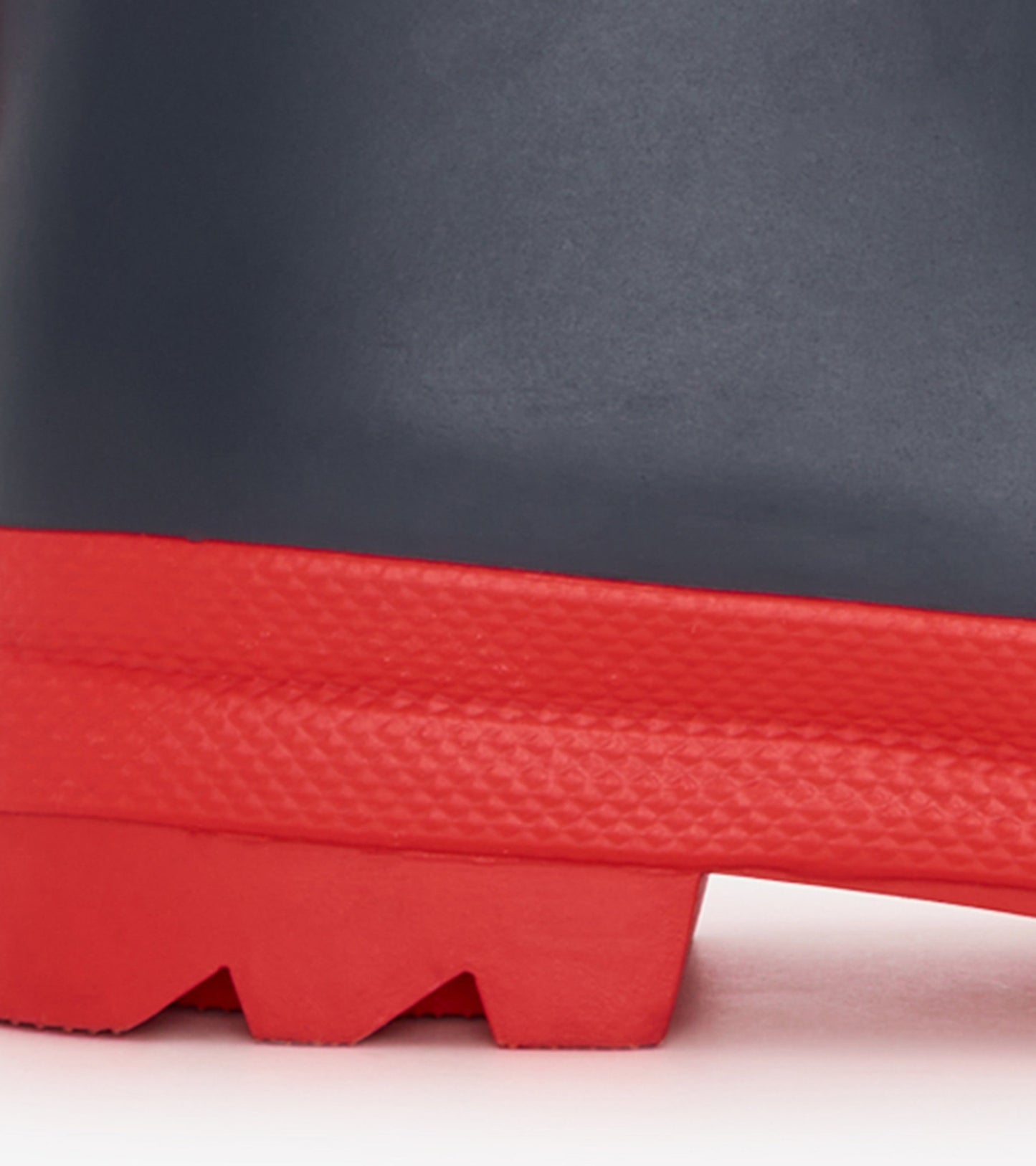 Navy and red matte rain boots with a textured sole, designed for kids, featuring a sturdy waterproof material.