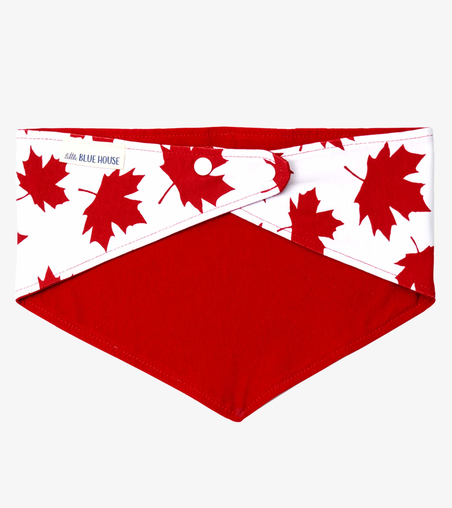Red dog bandana featuring a white section with red maple leaf patterns, designed for stylish pet wear.