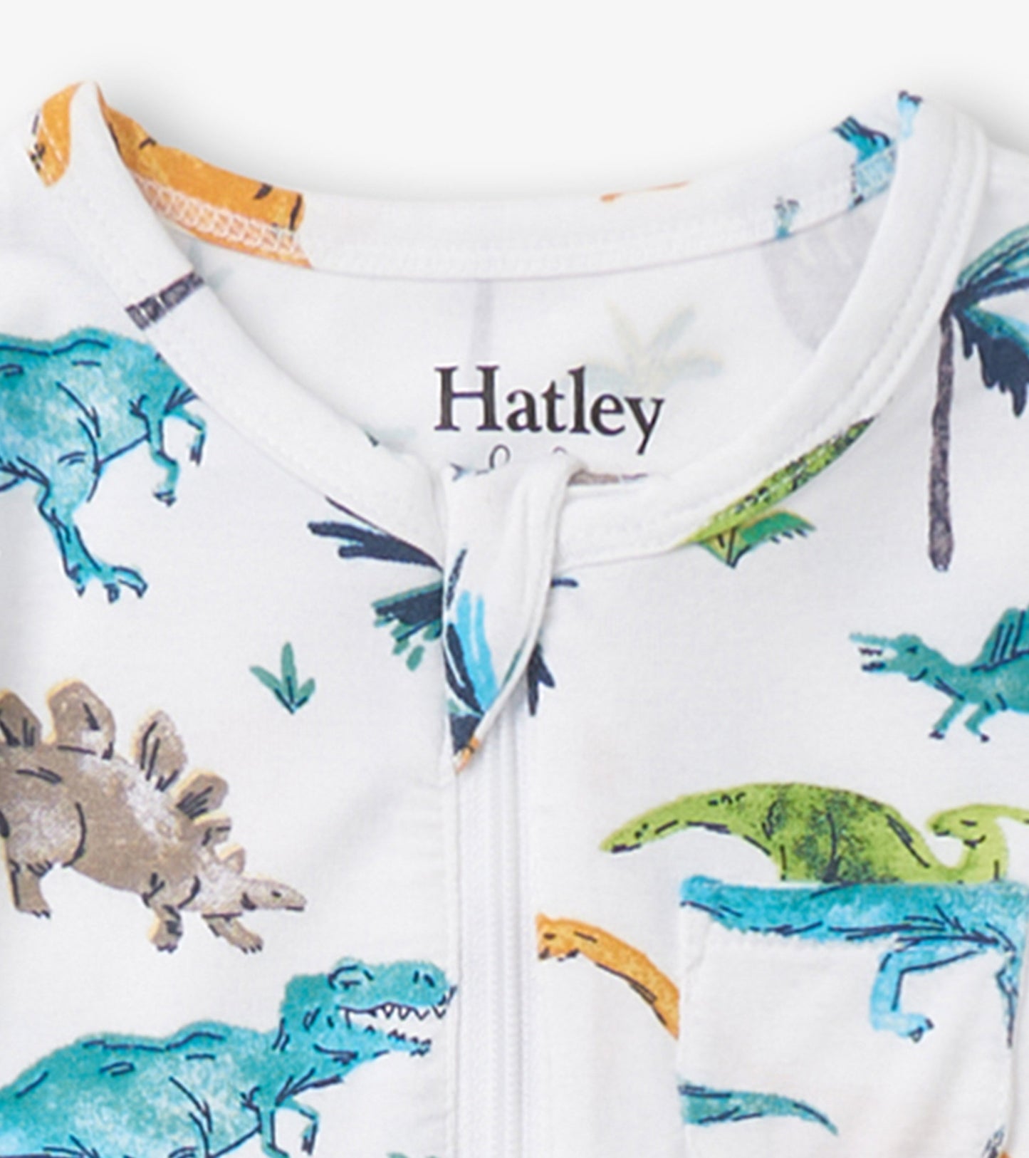 White footed sleeper featuring colorful dinosaur prints and a front zipper closure. Ideal for baby boys.