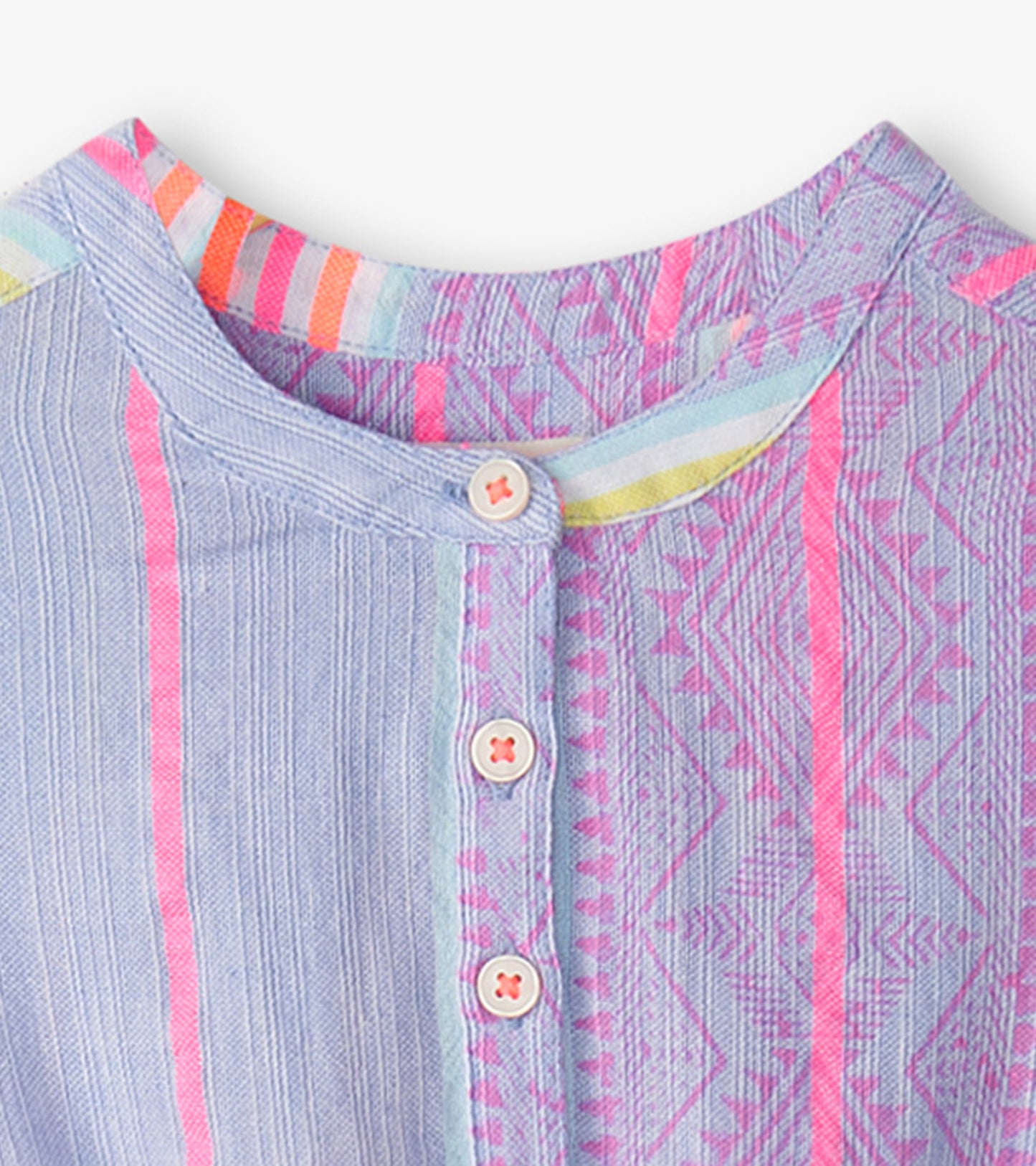 Light blue dress with colorful stripes and geometric patterns, featuring a smocked waist and button closure at the neckline.