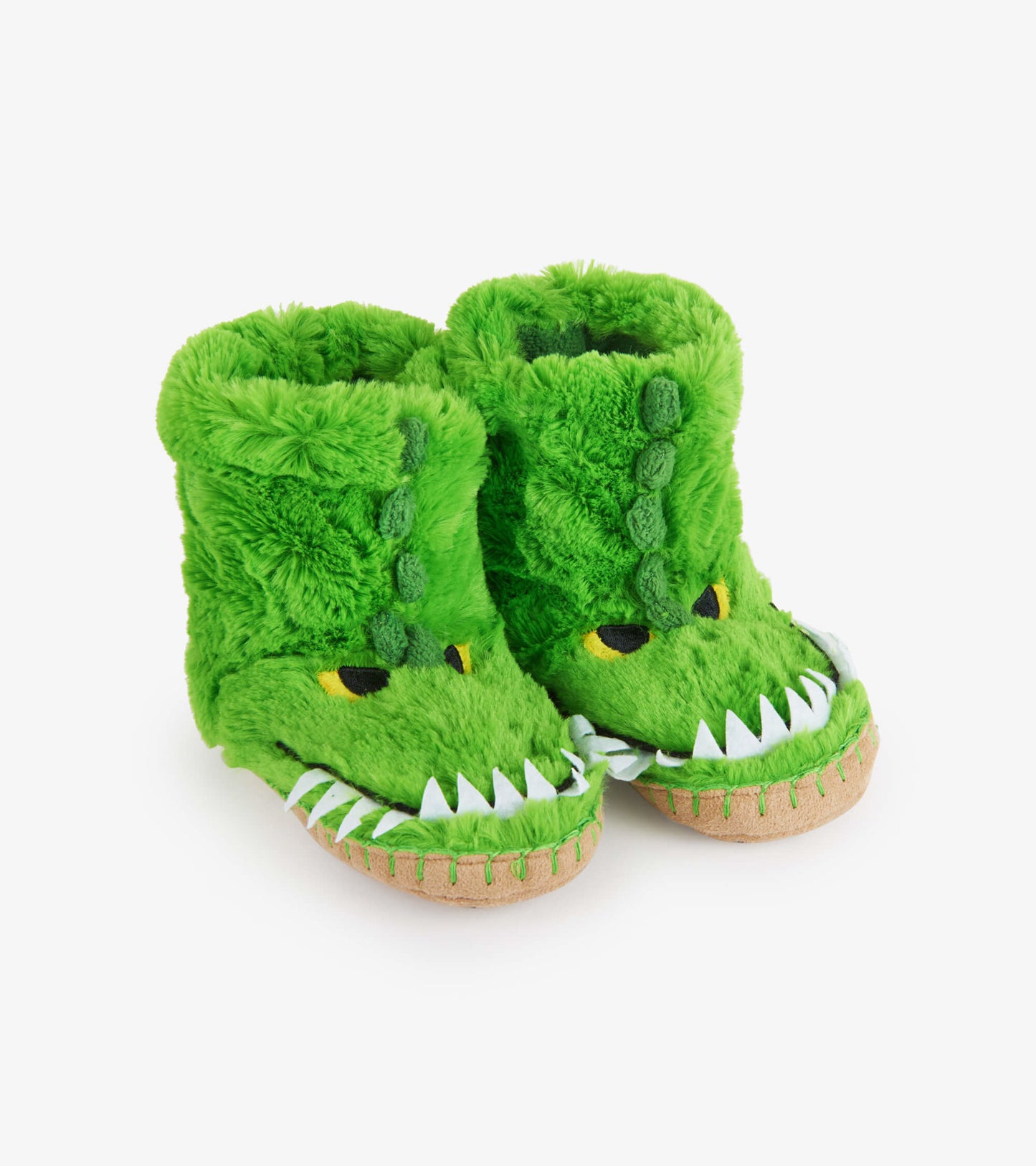 Green fuzzy slouch slippers shaped like an alligator, featuring eyes, teeth, and a soft, plush texture.