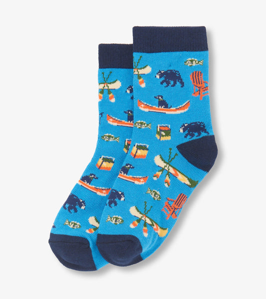 Blue crew socks featuring a playful lake-themed pattern with bears, canoes, and fishing motifs.