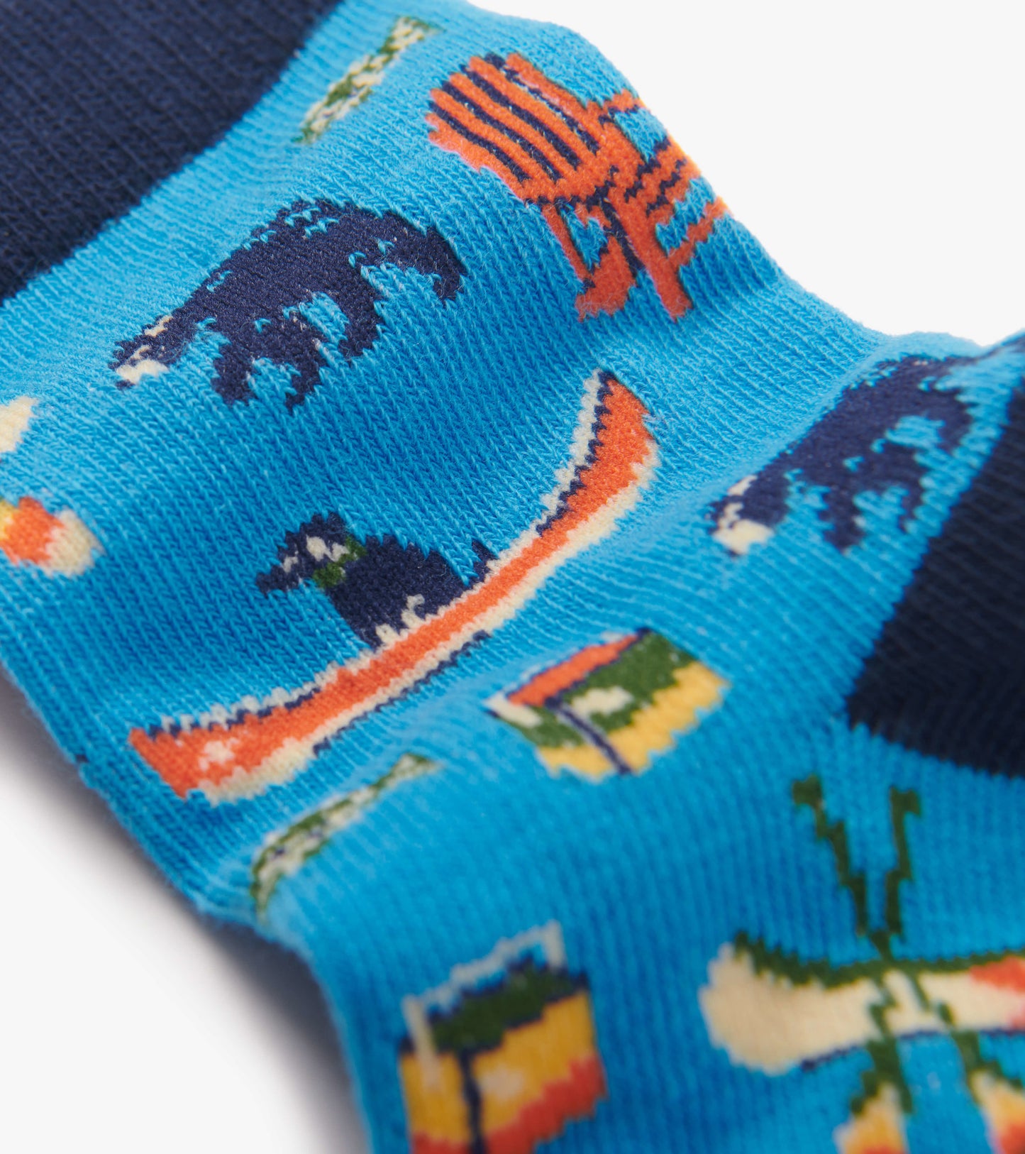 Bright blue crew socks featuring playful patterns of bears, canoes, and camping gear, with a navy cuff.