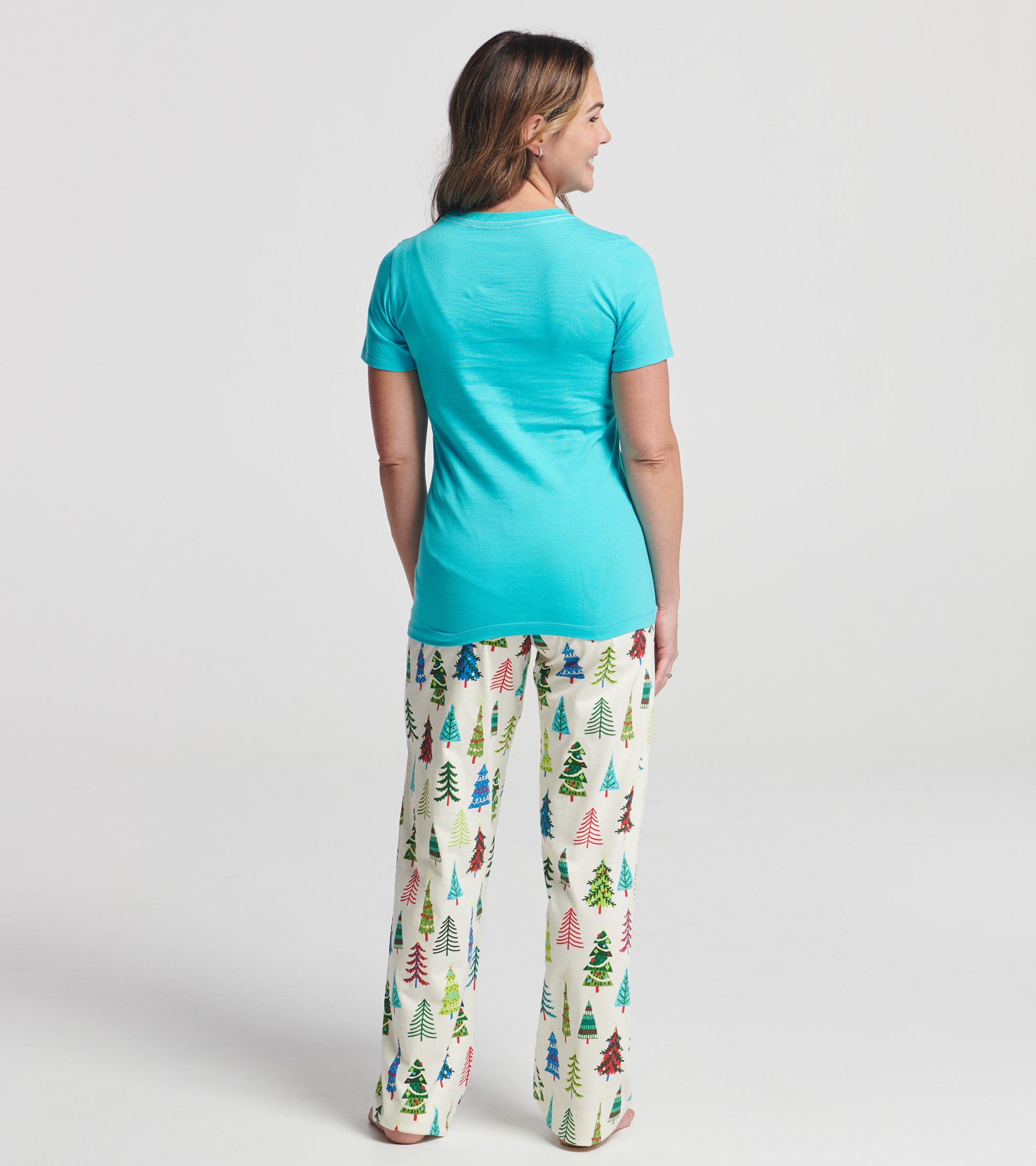 Turquoise short sleeve t-shirt with a fitted design, worn with festive tree-patterned pajama pants, viewed from the back.