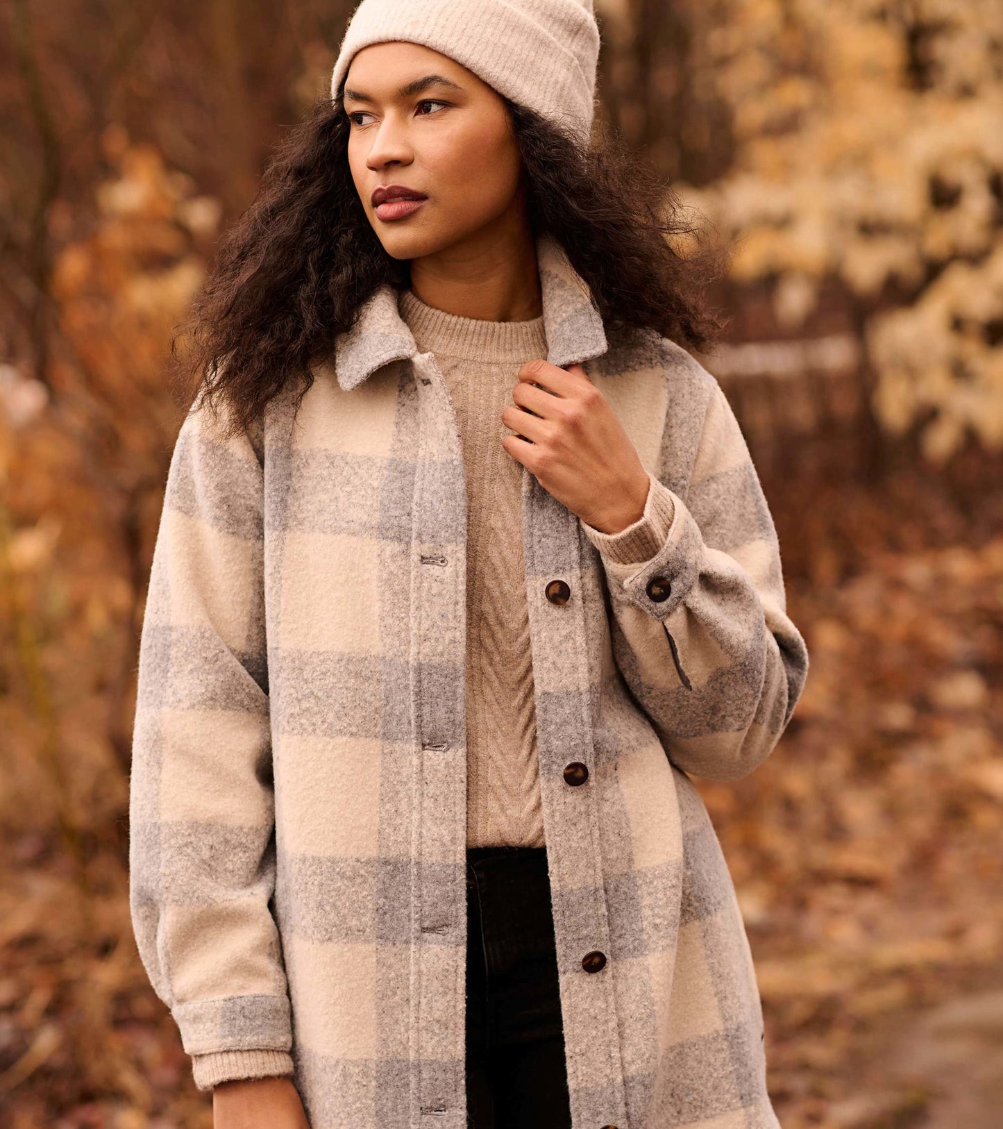 Neutral plaid overshirt in soft fabric, featuring a button-up front and relaxed fit, perfect for layering in cooler weather.