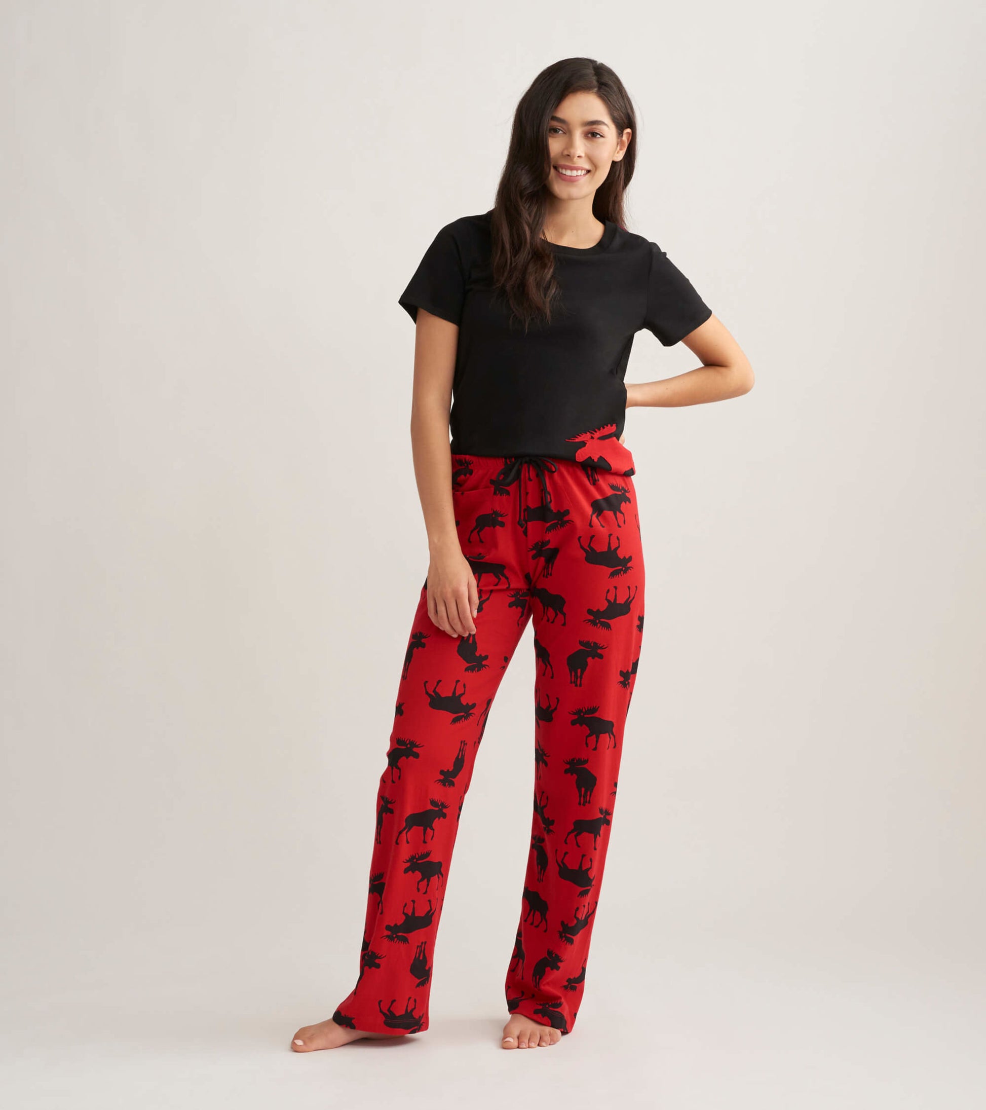 Red cotton pajama pants featuring a black moose pattern, designed for comfort and relaxation.