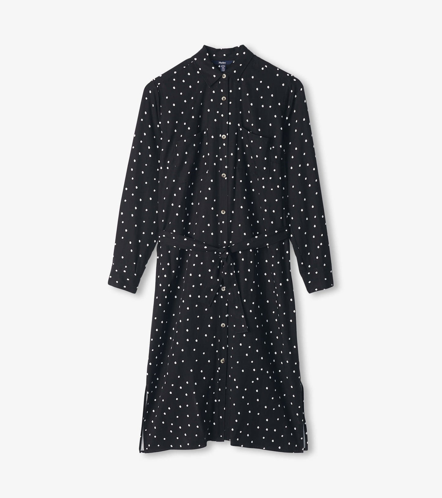 Black midi shirt dress with white polka dots, long sleeves, button front, and a tied waist.