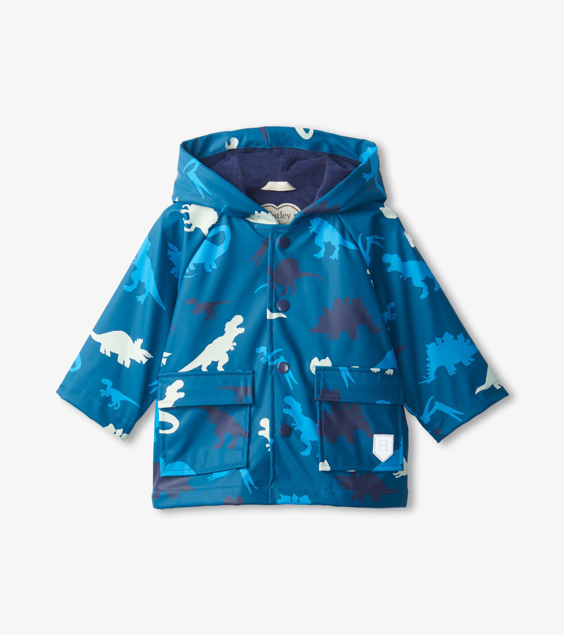 Blue dinosaur-patterned raincoat with a hood, featuring two front pockets and a snap closure. Suitable for babies.