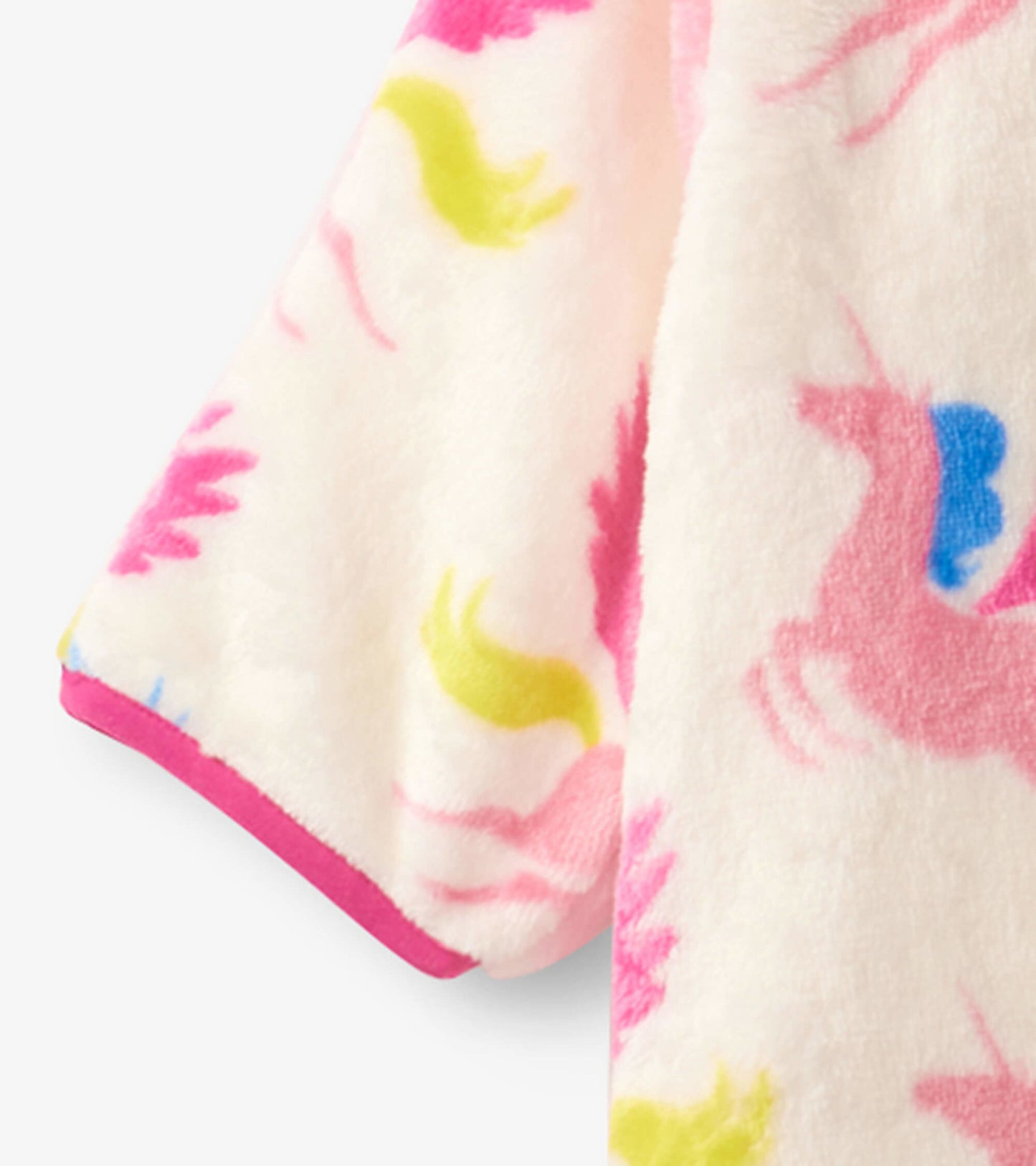 Soft fleece baby suit in cream with colorful unicorn and star patterns, featuring pink trim. Ideal for cozy wear.