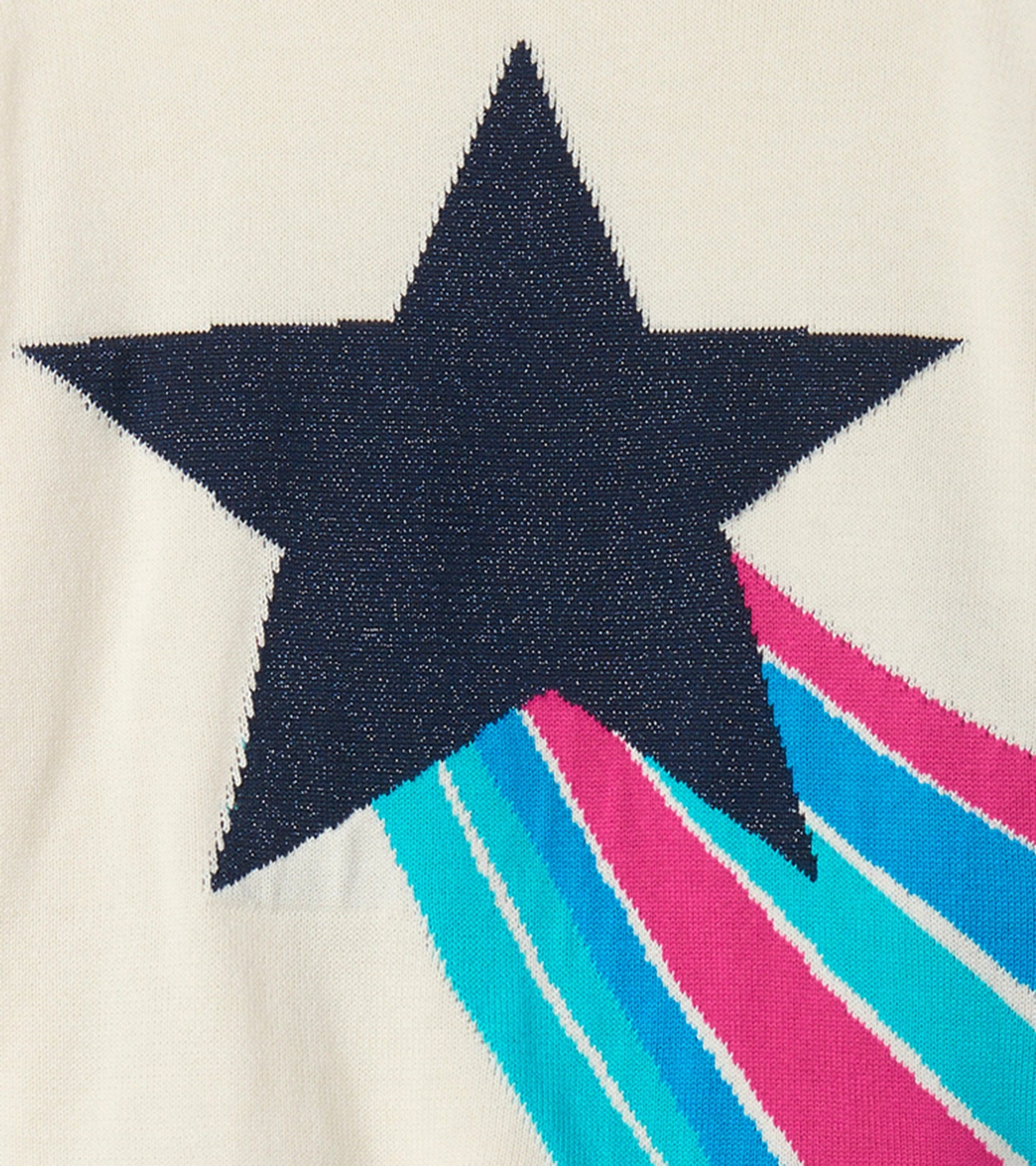 Cream sweater featuring a large navy star and colorful striped accents in pink, blue, and teal.