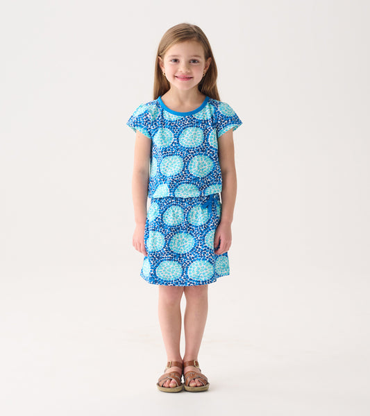 Blue patterned T-shirt dress with short sleeves and a flared skirt, suitable for casual wear.