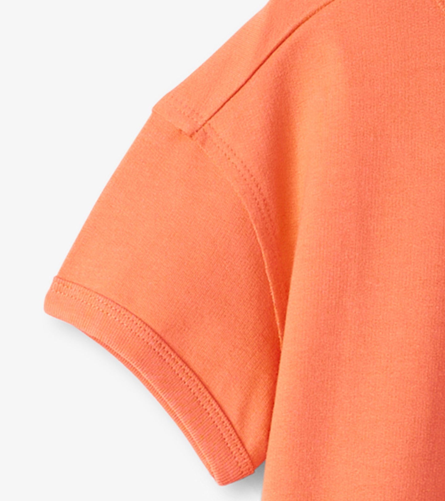 Short-sleeve graphic tee in bright orange with a soft texture, featuring a dinosaur design.