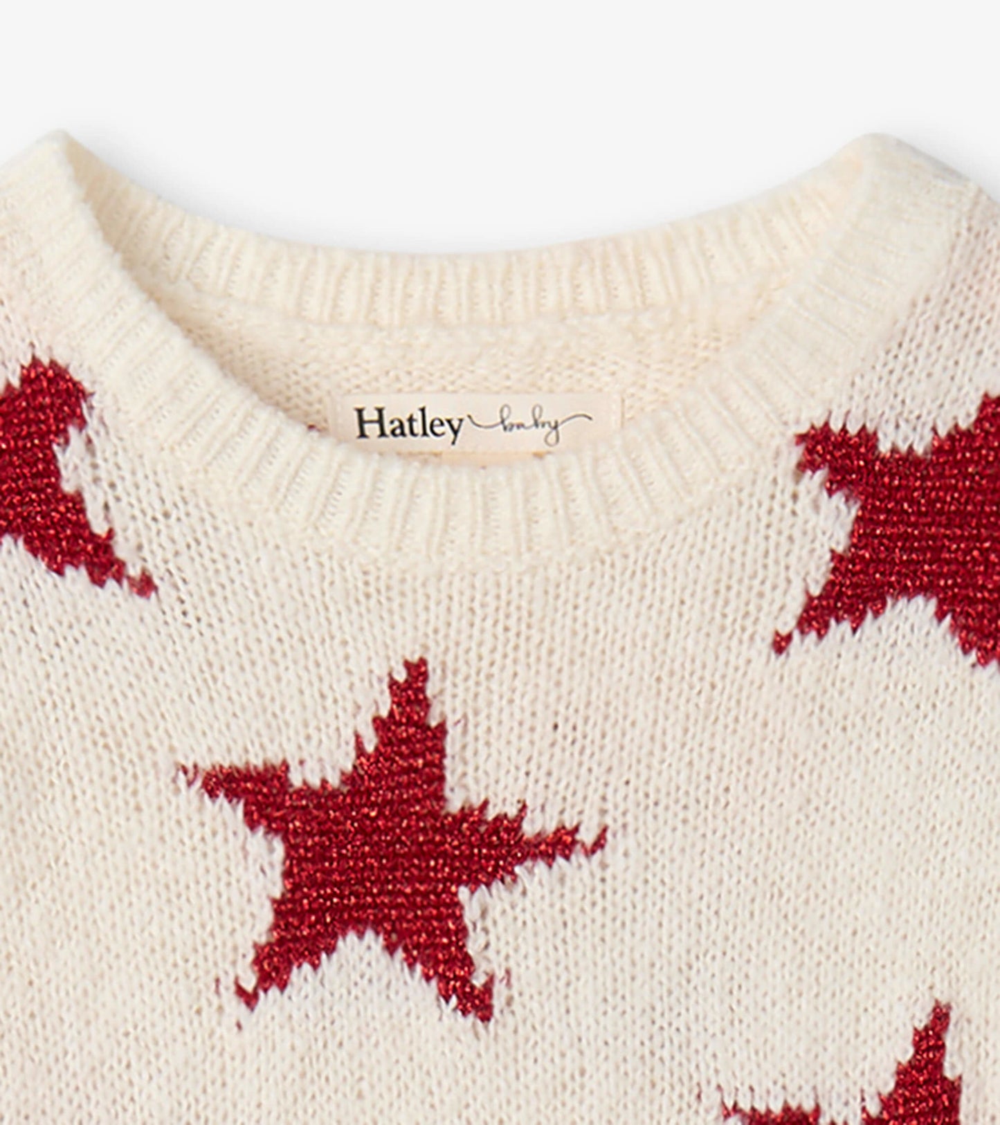 Cream sweater dress featuring red star patterns and a ribbed neckline, suitable for festive occasions.