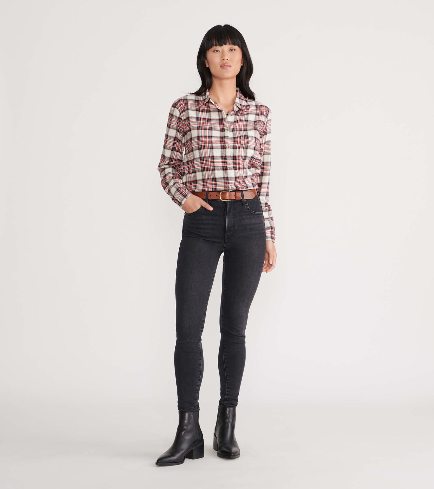Cream plaid flannel shirt with long sleeves, button-up front, and a relaxed fit, styled with black jeans and ankle boots.