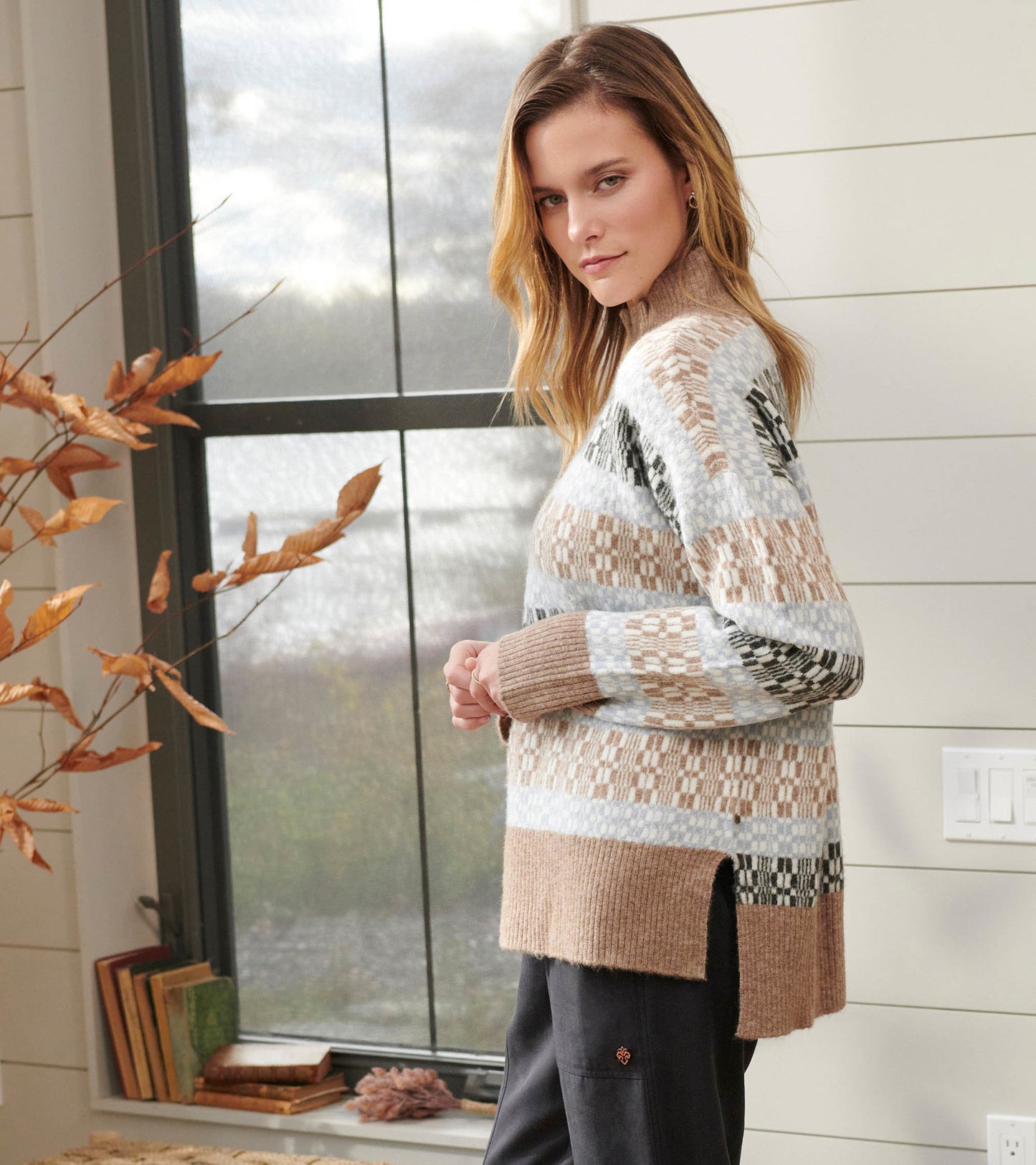 Mock neck sweater featuring a celestial plaid pattern in soft beige, blue, and black tones with side slits for comfort.