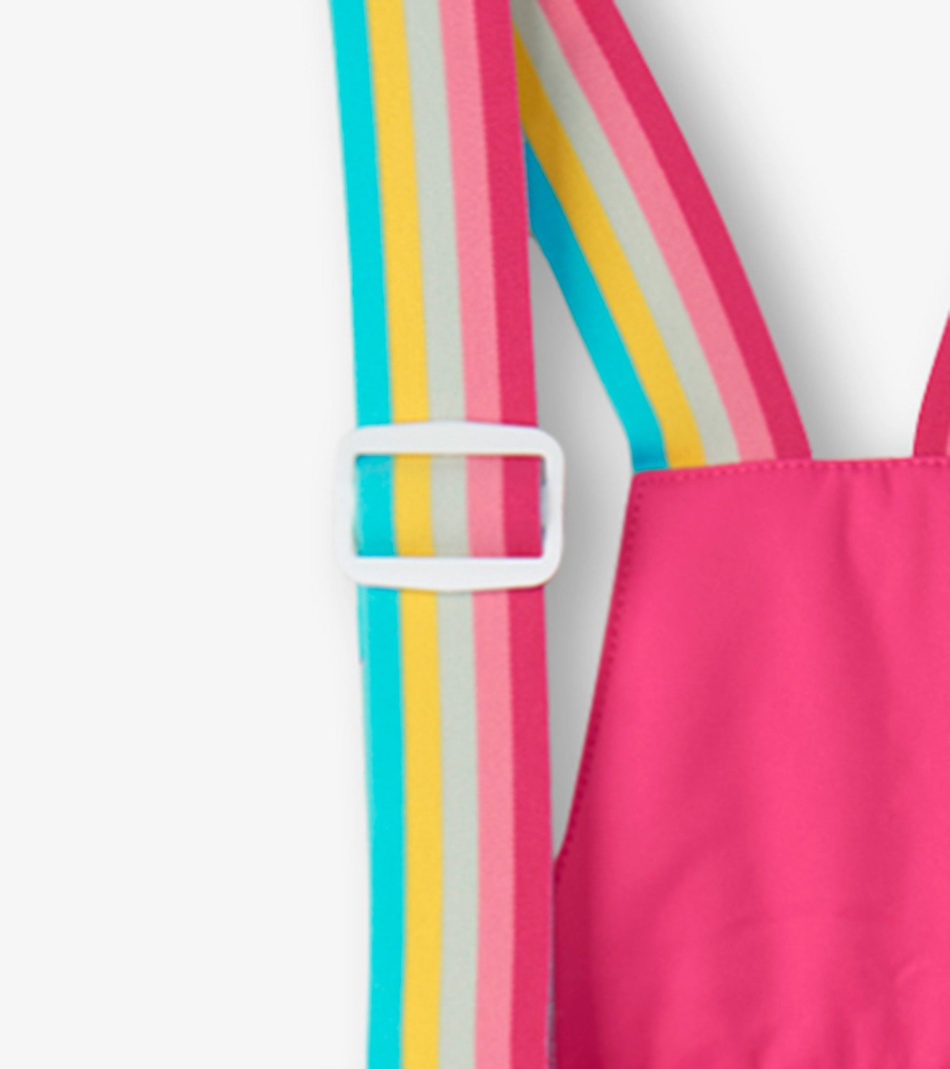 Bright pink snow pants with colorful striped suspenders, designed for kids' winter activities.