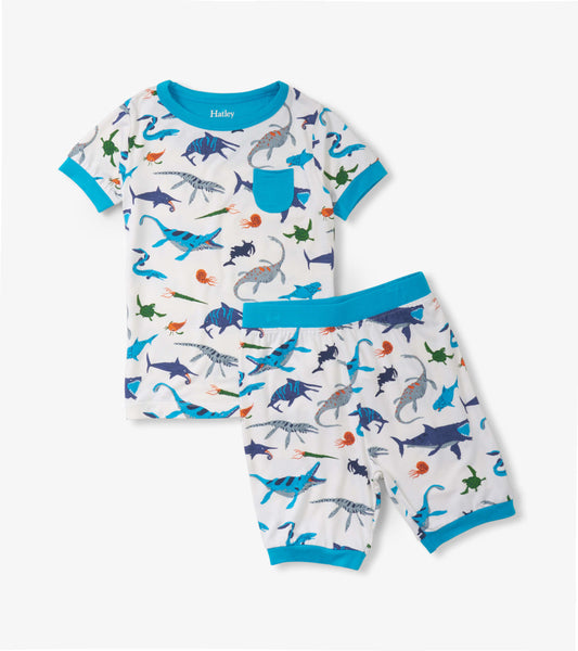 Boys' short pajama set featuring a colorful prehistoric marine life print on a white background with blue trim.