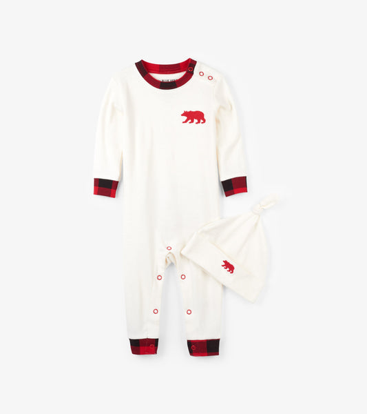 Cream baby sleeper with red plaid cuffs and bear embroidery, paired with a matching hat. Suitable for infants 3-24 months.
