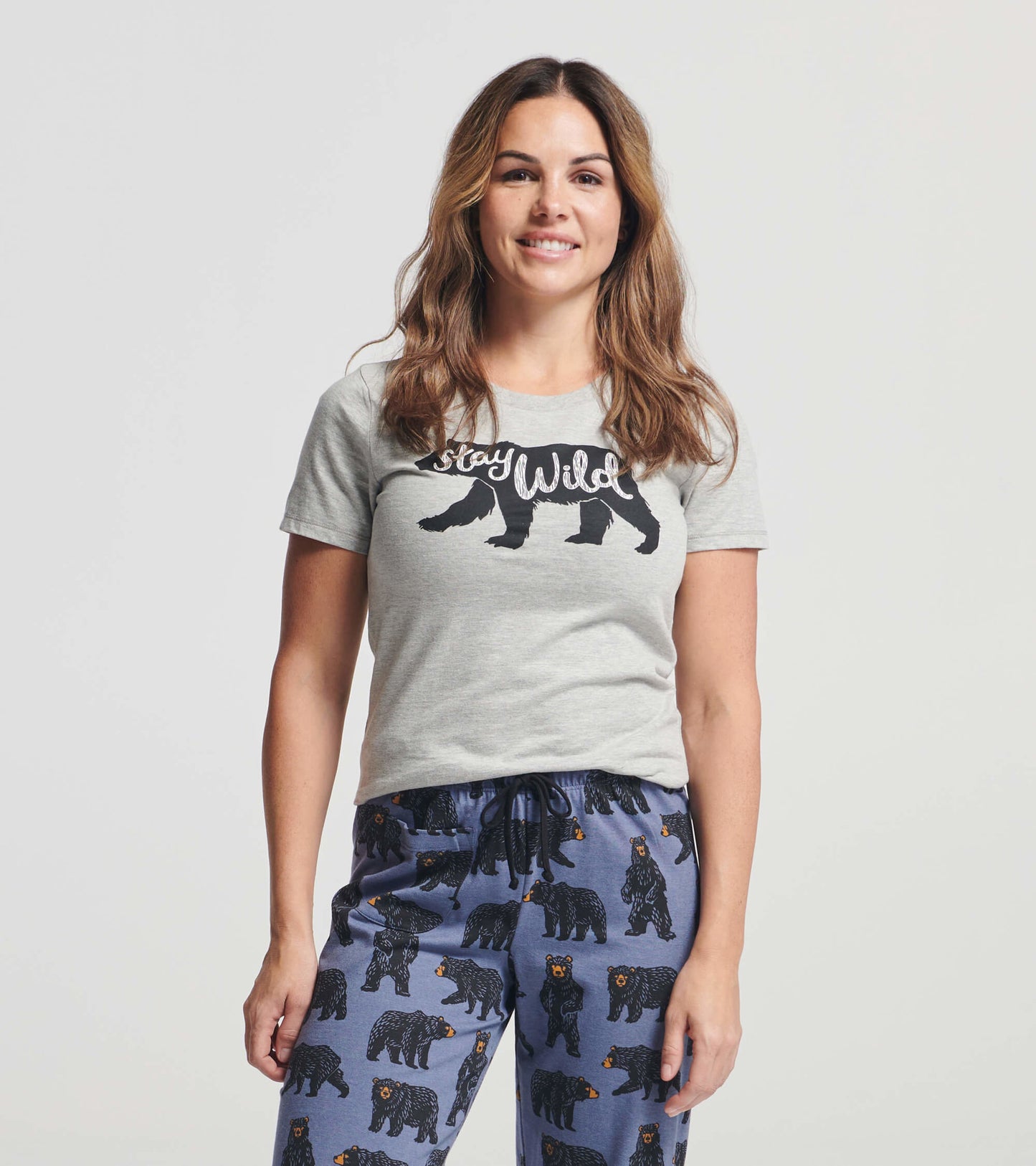 Gray women's pajama t-shirt featuring a "Stay Wild" graphic with a bear design, paired with patterned pajama pants.