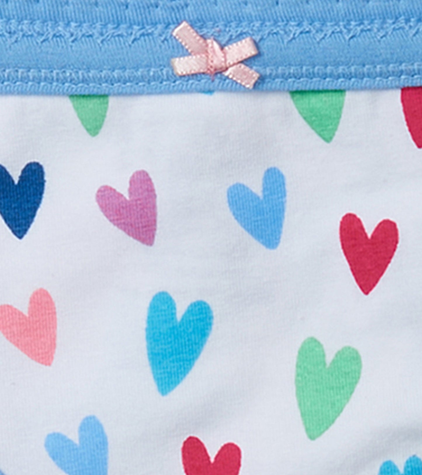 Girls' brief underwear with a light blue waistband and colorful heart patterns on a white background.