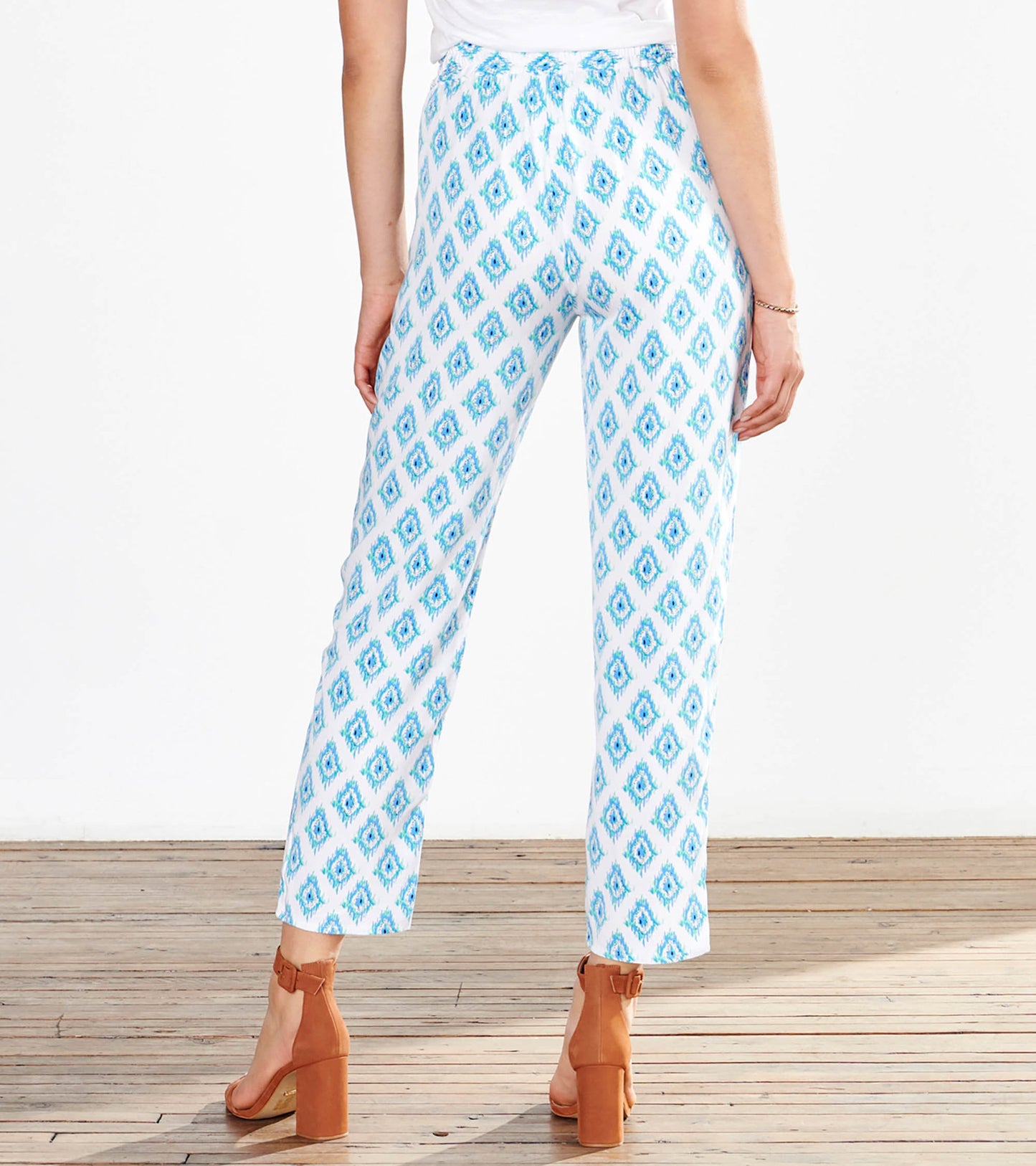 Light blue and white patterned pants with a diamond design, featuring a relaxed fit and ankle-length cut.