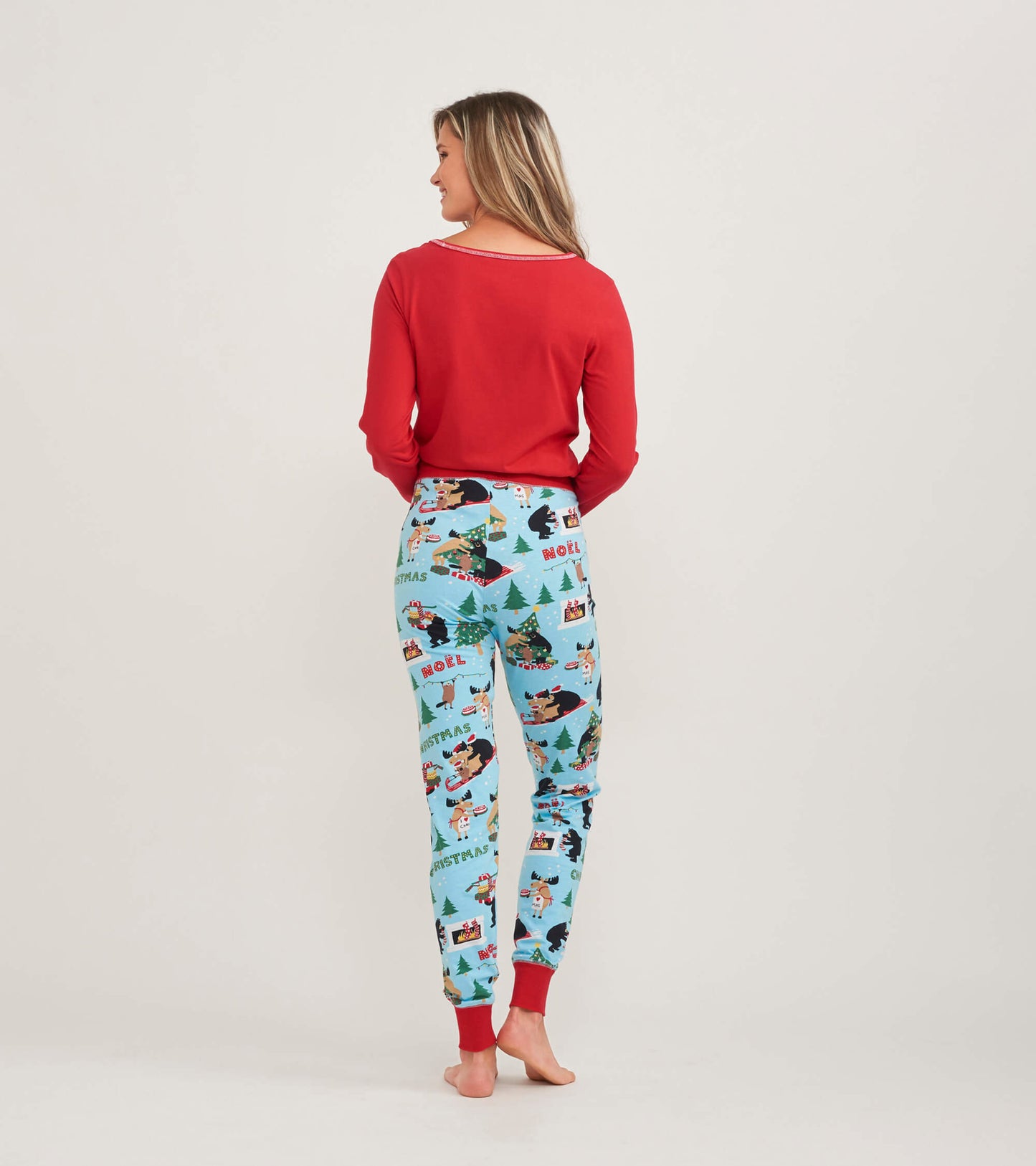 Red long sleeve pajama top paired with festive patterned pants, shown from the back.