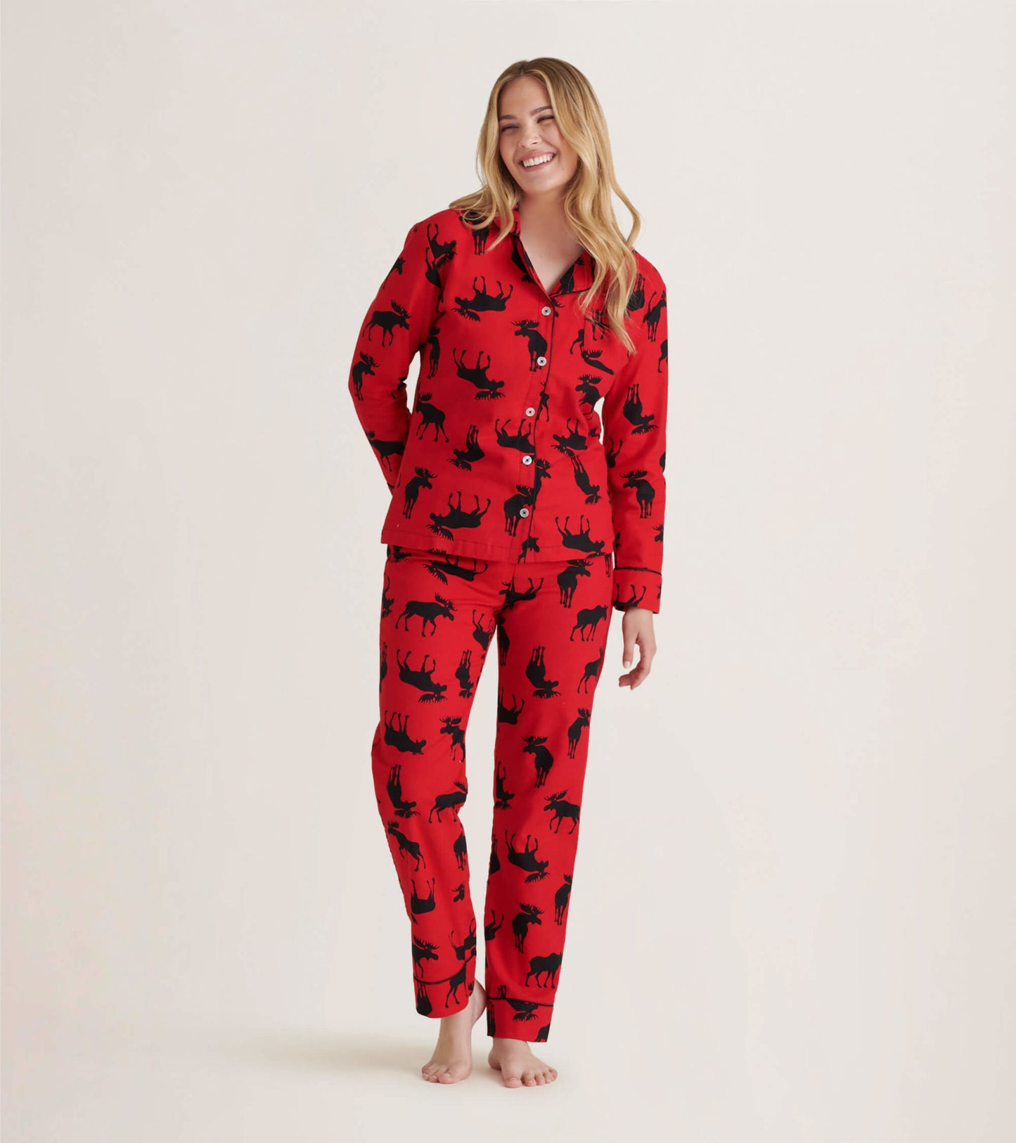 Red flannel pajama set featuring black moose patterns, includes button-up top and matching pants, ideal for cozy lounging.