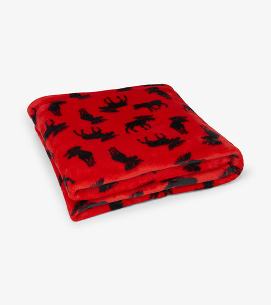 Red fleece blanket featuring black moose silhouettes, folded neatly.