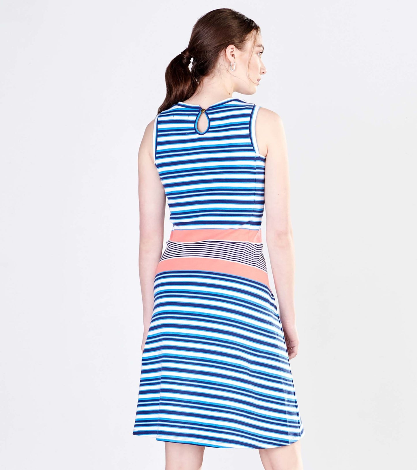 Back view of a sleeveless dress featuring blue and white stripes with a coral waistband and a keyhole detail at the neck.