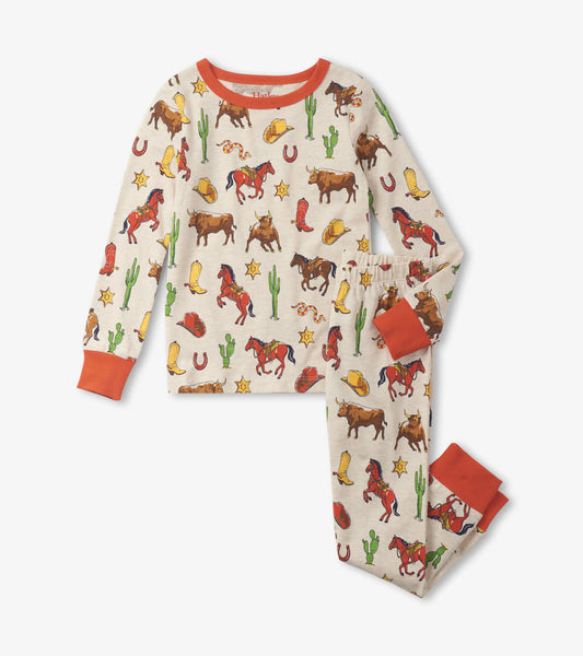 Cream pajama set featuring a vintage rodeo print with horses, cacti, and cowboy hats, accented with orange cuffs.