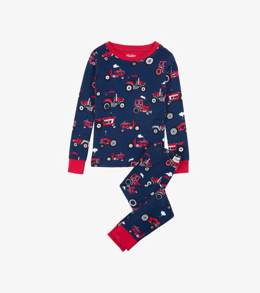 Navy organic cotton pajama set featuring red tractor patterns, with long sleeves and matching pants.