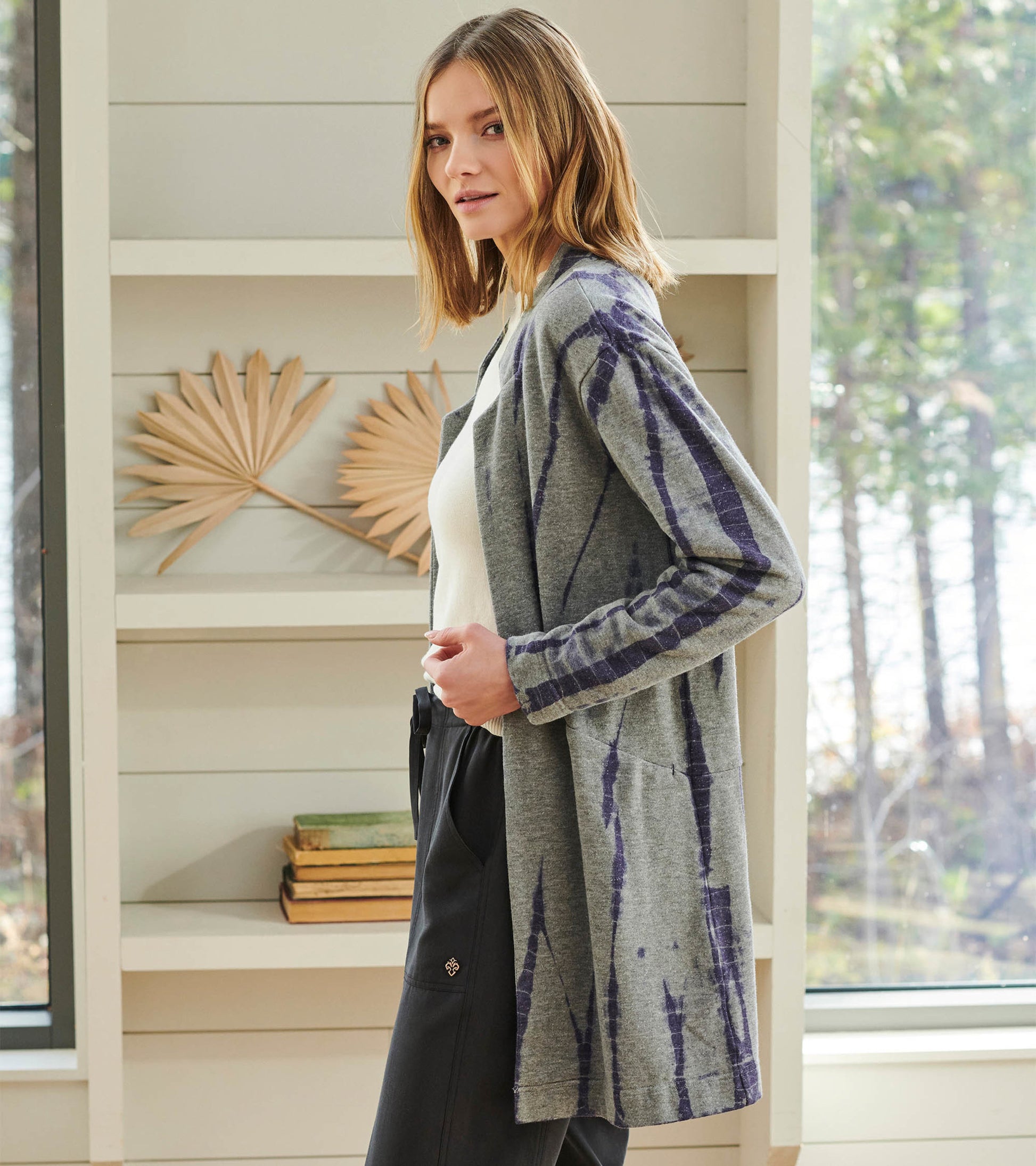 Long gray cardigan with storm tie-dye pattern, featuring open front and pockets, styled with a white top and black pants.