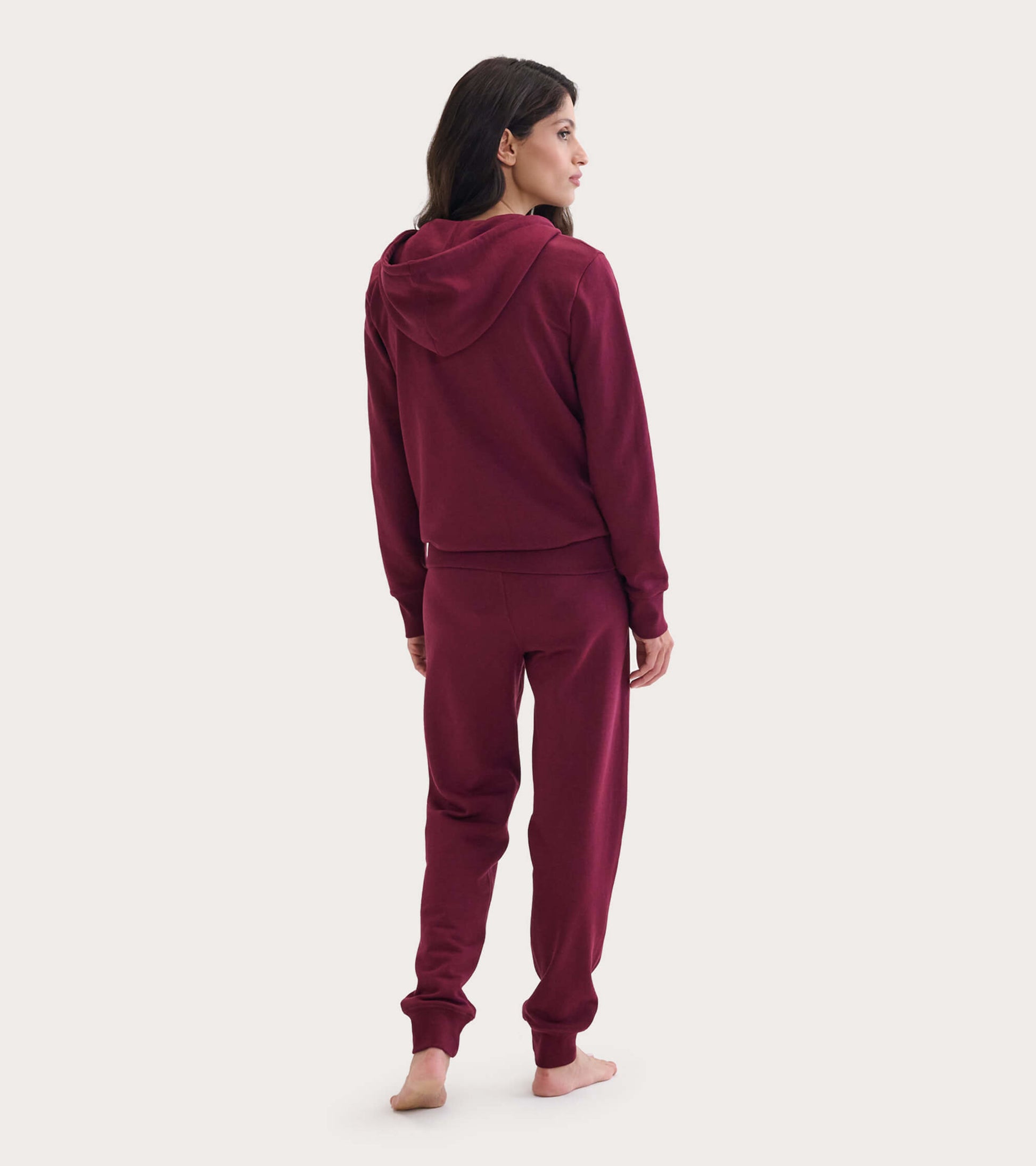 Maroon full zip hoodie with a hood, shown from the back, paired with matching joggers. Soft, casual fit.