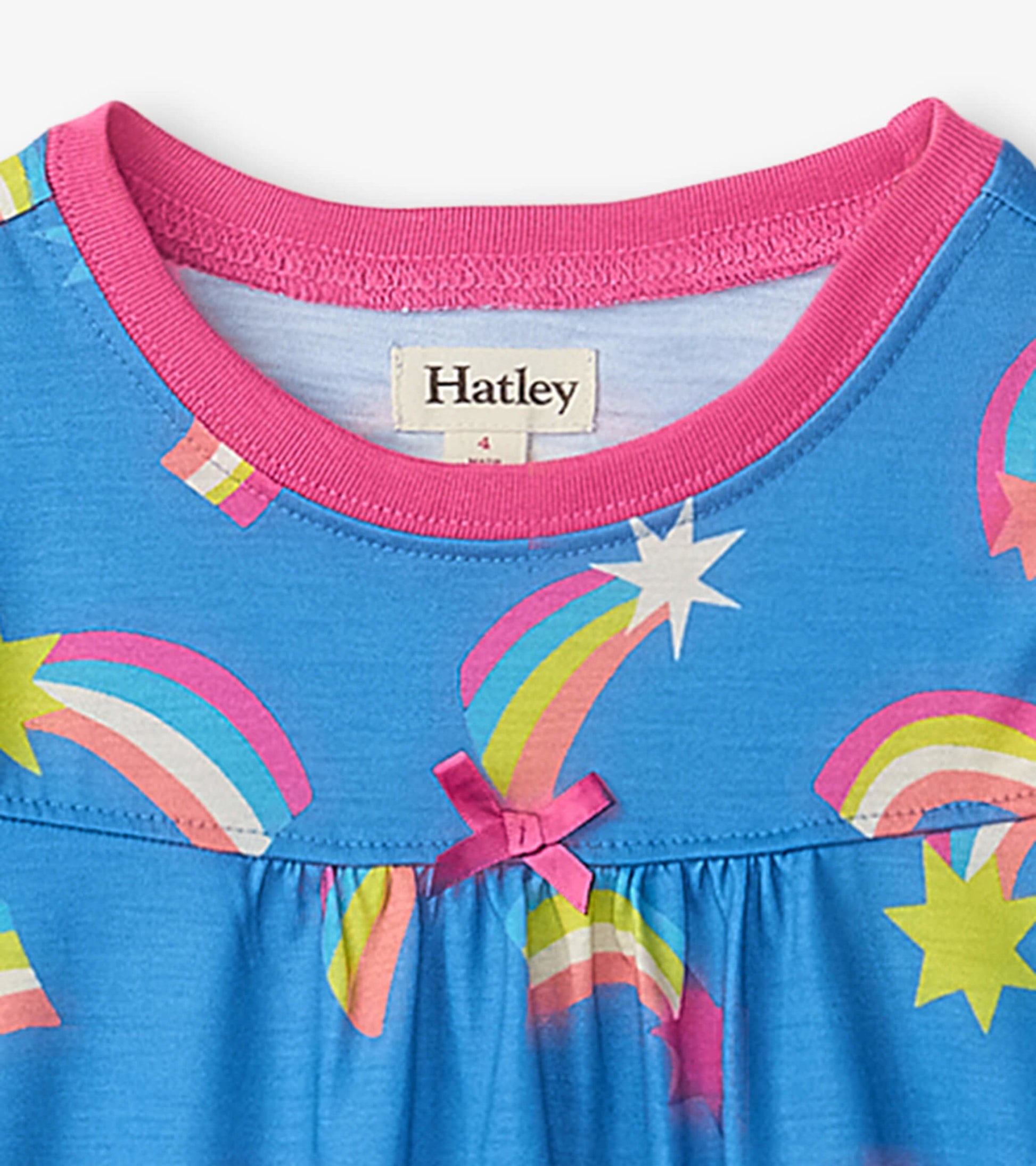 Blue long sleeve nightgown featuring colorful shooting stars and rainbows, with a pink neckline and a bow detail.