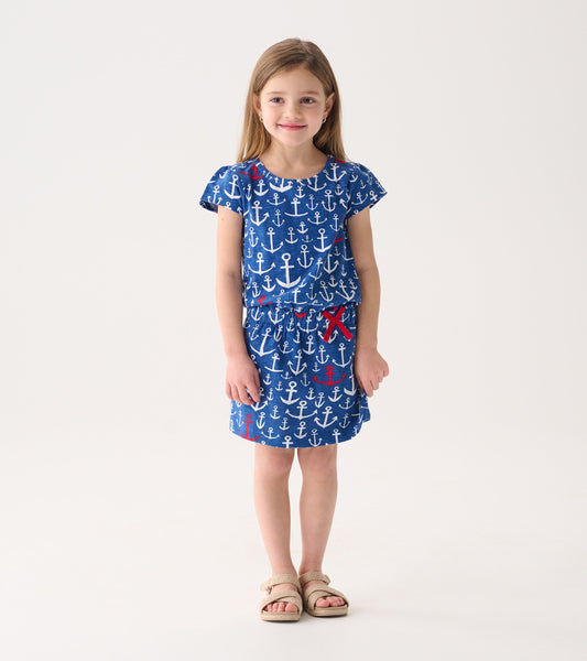 Blue t-shirt dress with white and red anchor pattern, short sleeves, and elastic waist, suitable for casual wear.