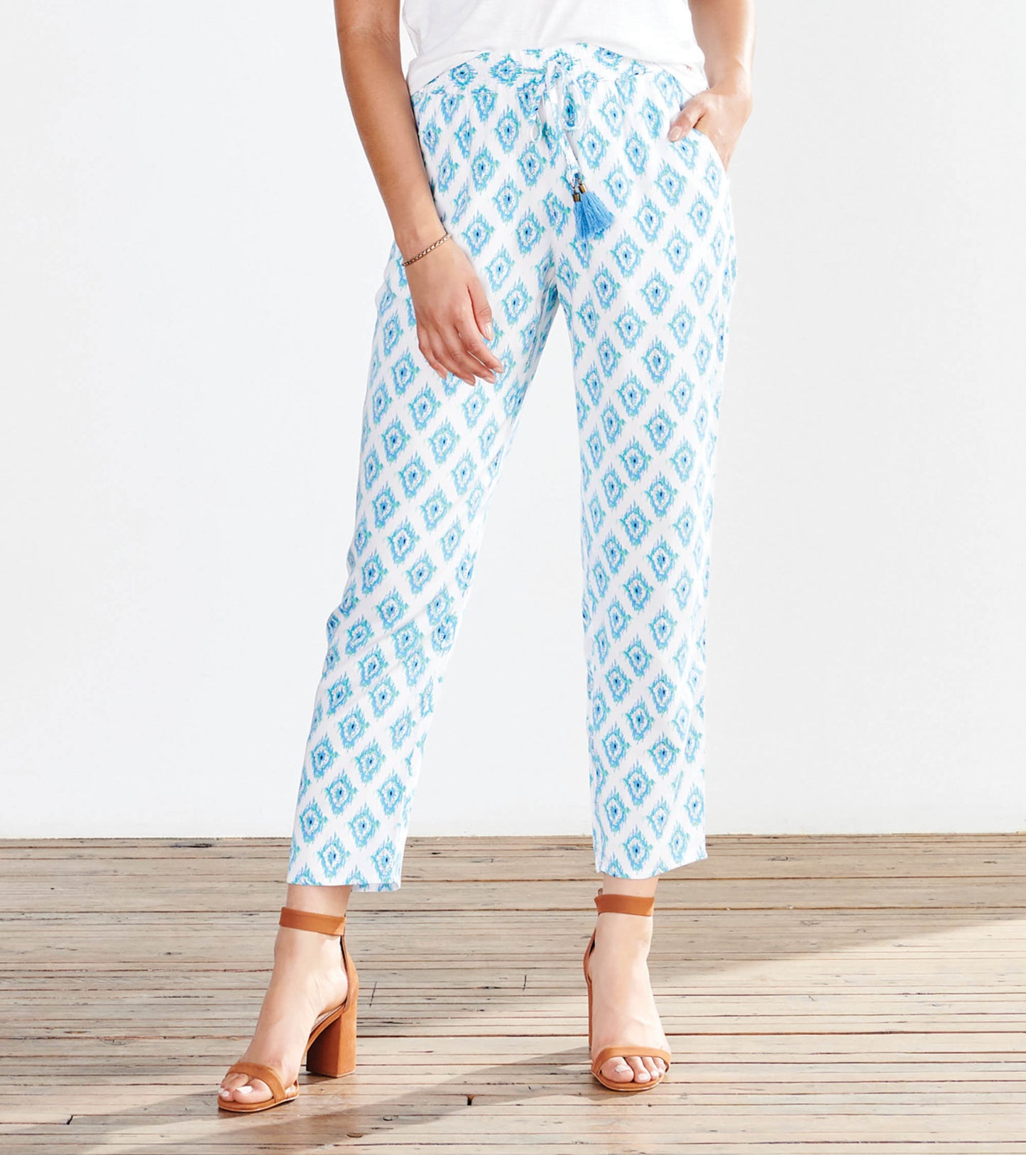 Light blue patterned pants with a drawstring waist, featuring a diamond design and relaxed fit.